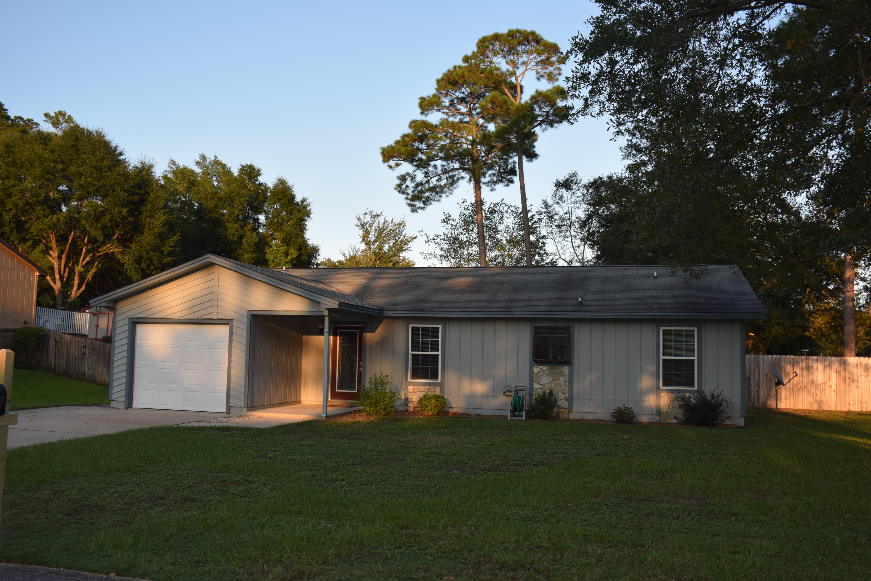 Lovely updated home in the heart of Niceville on a large corner lot. This 3/2 home has a split floorplan with a large living room & eat-in kitchen.The kitchen has stainless appliances, granite countertops, breakfast bar & updated lighting. In the living room there is a wood-burning, stone-clad fireplace & double sliding French doors that lead out to a patio and the beautiful yard.The master bathroom is updated with a quartz vanity & decorative tile shower. The 2nd bathroom also has an updated vanity & tiled bathtub surround.The house sits on a huge .34 acre corner lot with a fenced back yard,large yard building (conveys as is) & double gate. Please note the new dimensional shingle roof just installed! Close now & be ready for the holidays!