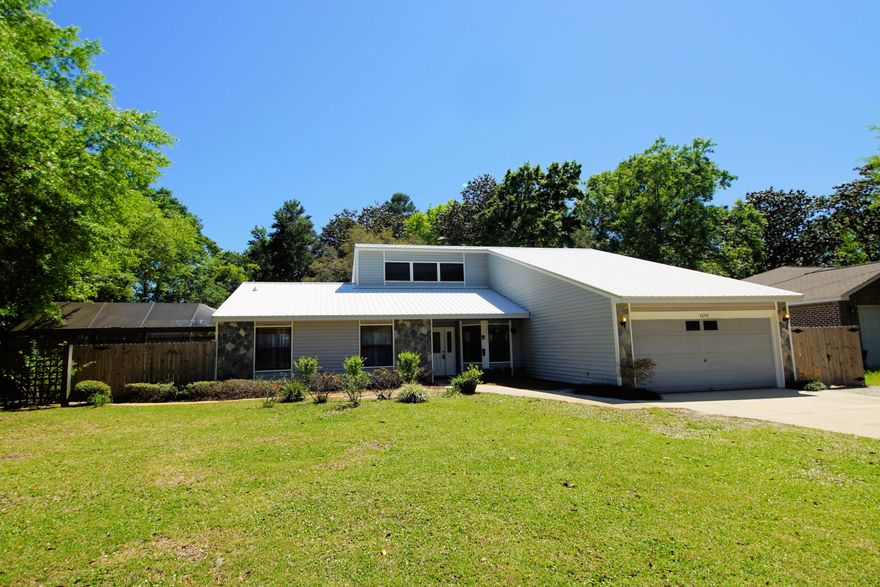 Beautiful four bedroom home with a pool, updated kitchen & metal roof in Bluewater. Lanai covered saltwater pool & spa with herringbone pattern pavered deck is the perfect spot for entertaining. Large sun room, plenty of windows & natural light, leads to the pool & is accessible from the living room & master bedroom. This great backyard is the quintessential location for roasting s'mores while sitting on huge logs surrounding the fire pit. There is plenty of room to add a garden, playground, sandbox, trampoline, tree house, or add a deck. Great flowing split bedroom floor plan with formal dining room, living room with vaulted ceilings, & renovated kitchen containing new cabinets, tile back splash, quartz counters, stainless appliances & a Butcher Block Island with pot rack. The whole house, other than the master bed & master bath, has been repainted with washable paint which is terrific for those with small children.  Large storage shed in the backyard.  Buyer to verify all dimensions.  