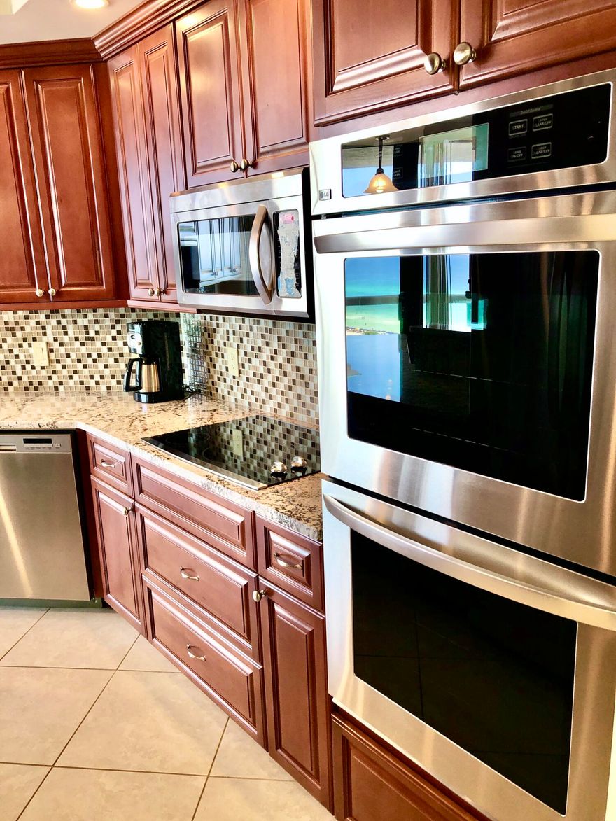 Practically perfect in every way, and a coastal retreat, best describes this beautifully updated condo at Destin Surfside!  It's all been done for you. The kitchen is fabulous with stainless steel appliances, double ovens, a smooth top stove, refrigerator with ice maker, dishwasher, microwave oven, and even a built-in ice maker.  Granite counter tops cover the extended serving bar and breakfast bar which add storage. The wood cabinetry, double stainless sinks, faucet and lighting complete the remodel.  The master and guest baths have also been updated with similar cabinetry, granite, fixtures and lighting. The master bath is like a luxury spa.  The spacious double vanities are an upgrade.  And the shower with it's coordinating tiled walls, flooring, and rimless door is very stylish indeed