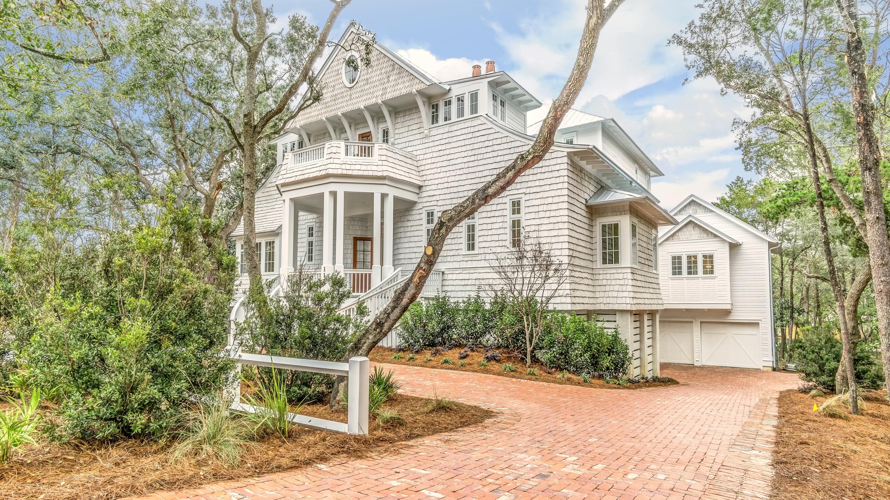 This spectacular old Seagrove Estate is a world unto itself--masterfully blending coastal luxury and sophistication with the wild natural beauty of Seagrove Beach, mere steps to SEASIDE, FLORIDA and the beaches of 30A. A symphony of wood, glass, and stone, the home's design, materials, amenities and craftsmanship are peerless. The expansive residence includes 7 bedrooms, 8 bathrooms, a bunk room, 4 family gathering rooms, 3 laundry rooms, an elevator and a lavish carriage house for guests. The chef's kitchen with custom cabinetry and lighting and high-end appliances is perfect for the cook in your family. The two-story great room includes a cozy fireplace for cool beach night, offering the perfect location for your next soiree or family gathering. Creating an excellent flow