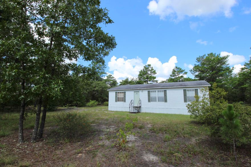 In unbelievable like new condition! Simple, neat and clean - even without any holes in the walls for pictures! Nearly 5 acres of mostly lightly wooded land and a blank slate for what you might to build or add. Kitchen with new refrigerator & new washer is open to the living room and even includes desk space for office or homework. Master bedroom is generously sized with walk in closet. New HVAC in 2014. Very few in this price range (and with acreage!) come on the market in this condition, so don't delay! Please do not enter the driveway - home cannot be seen from the road and is occupied. May be seen by appointment only.