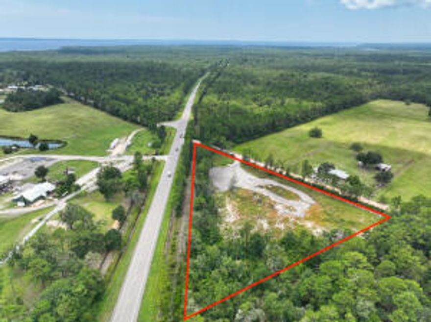 Build your dream home with plenty of room to breathe!  Country living with plenty of privacy.  Residential Lot just shy of 5 acres has been partially cleared.   This triangular lot with 912' facing Highway 20 and 646' facing King Road has an access with a gate to the cleared area on King Road.  A buffer of trees along Highway 20 provides privacy and a privacy fence has been installed on either side of the gate.  Gulf of Mexico beaches within 30 minutes by way of the Highway 331 Bridge.