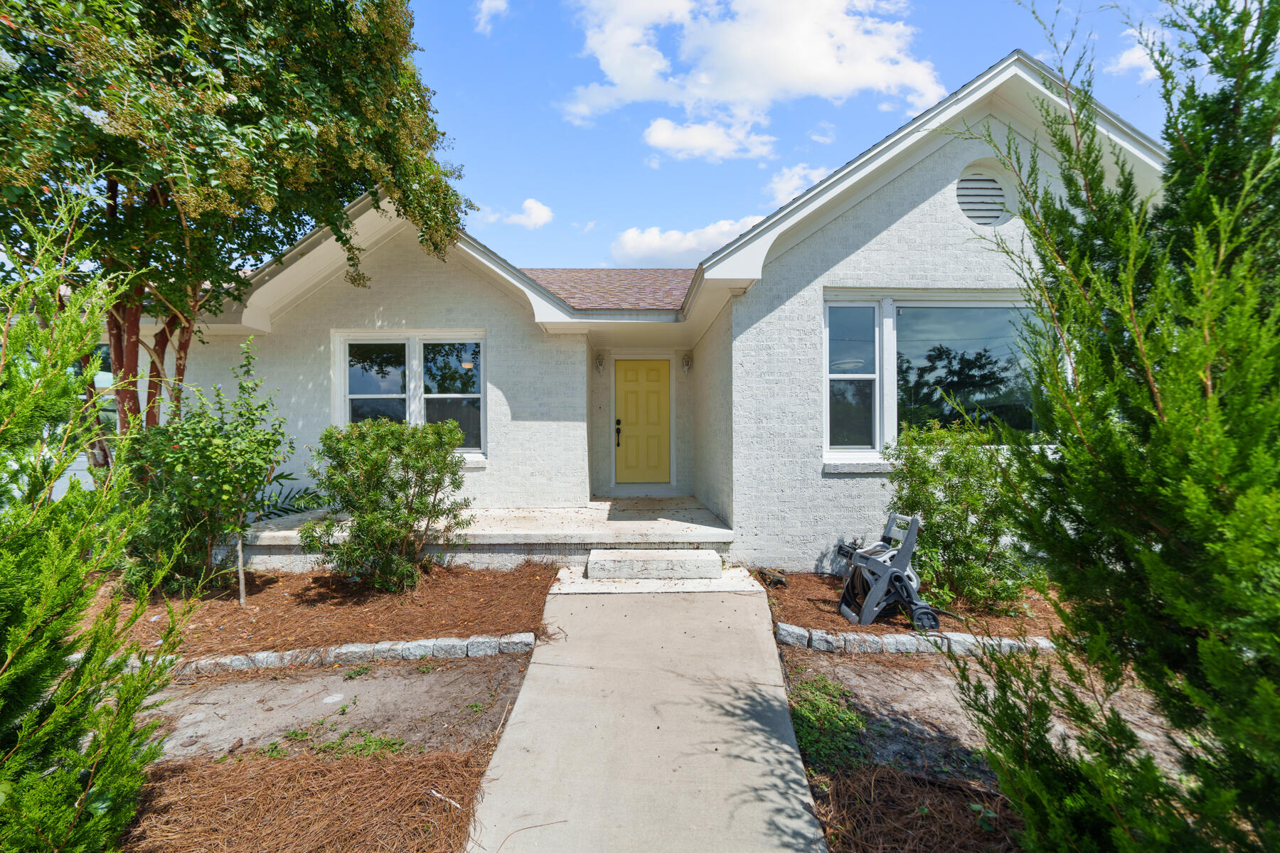 CURRENTLY UNDER CONTRACT - SELLER ACCEPTING BACK UP OFFERS. A rare find in the heart of THE COVE! On this HALF ACRE in the historic Cove neighborhood, you'll find a great opportunity to have privacy and room to grow. Even ROOM FOR A POOL! This adorable Cove cottage boasts almost 2,100 square feet making it one of the larger homes in the Cove and has 3 bedrooms, 2 bathrooms, a home office/flex room, 2-car garage and best of all - it's on a corner homesite on a half acre! This home features original hardwood flooring throughout, recently painted interior with an open floor plan full of character that is flooded with natural light. As you step onto the circular driveway, you're welcomed with knockout roses, a beautiful array of apple and peach trees and a freshly painted white brick Cove cottage with an adorable welcoming yellow door! Entering the home you will enjoy a spacious foyer that leads into the living room that is remarkable! The living room offers a wood-burning fireplace, oversized window and also easy access that leads to the home office and dining area.
The kitchen offers stainless steel appliances, quartz countertops and a cozy breakfast bar. The kitchen leads to the laundry/mud room and the 2-car garage and open deck overlooking the lush backyard. The master suite is a DREAM! This room has great natural light overlooking the back yard with two large walk-in closets, a separate water closet and wooden vanity with an oversized walk-in shower. The master suite also includes access to the back yard deck offering easy access to enjoy morning coffee in the privacy of your spacious back yard!
This homesite is such a rarity in the Cove boasting a half acre giving you ROOM FOR A POOL, room to continue to garden and also only being a few blocks from the Bay! The back yard was recently fenced with privacy fencing, as well. Another incredible feature of this back yard is that is backs up to an alley so perfect to install a large gate in the recently installed 6' privacy fence so you can park your boat, trailers, etc. secured in your own yard - with NO HOA, this is a no brainer!
A newly installed deep well operates all the water to the home and irrigation and features reverse osmosis. Your utility will bills will be much lower with this home and you'll have peace of mind if the electricity is out having water no matter what! City water is hooked up and can easily be turned back on if the new owner desired.
This home is an incredible opportunity to own your own functioning FOOD FOREST with juicy peaches, delicious apples, tasty asparagus, tangy olives and so much more! Easy drip irrigation from the deep water well was also installed making it as easy transition for the new owner to have a low maintenance garden! This property has it all. It even has chickens and a well-built chicken coop in the back yard! The chickens will convey with the home if the buyer chooses creating an amazing option for a Buyer to have fresh eggs year-round in addition to the abundance of fruits and vegetables.
The Cove is a charming golf cart-friendly community with NO HOA and highly sought after for it's water views as well as its city-maintained playgrounds and parks. You'll also enjoy a baseball field and new playground area for kids and families. Enjoy events in the community throughout the year! This neighborhood is adjacent to the fast-growing downtown Panama City area which features restaurants, a marina, shopping, breweries, farmers markets and events year-round. Beach Drive is also where you will find the best sunsets in Panama City and you can enjoy the newly installed multi-use path leading from your home to the sunset nightly!
The St. Andrews Bay Yacht Club is a private club with an incredible offering as an additional amenity in the neighborhood and just a few minutes away. Ideal for boaters, fisherman and those who love to enjoy events, as a member, you will enjoy access to a private boat launch, dining waterfront and activities weekly.
Make THE COVE your home today!
