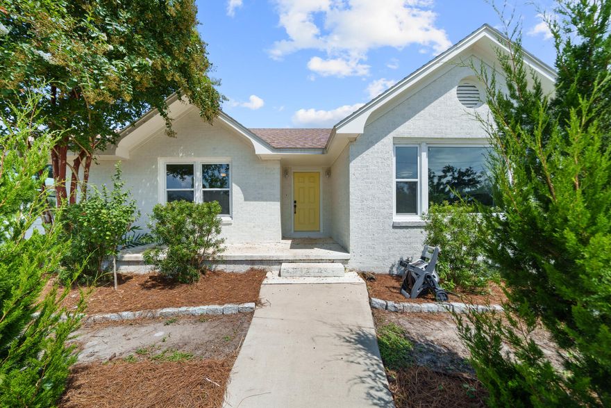 CURRENTLY UNDER CONTRACT - SELLER ACCEPTING BACK UP OFFERS. A rare find in the heart of THE COVE! On this HALF ACRE in the historic Cove neighborhood, you'll find a great opportunity to have privacy and room to grow. Even ROOM FOR A POOL! This adorable Cove cottage boasts almost 2,100 square feet making it one of the larger homes in the Cove and has 3 bedrooms, 2 bathrooms, a home office/flex room, 2-car garage and best of all - it's on a corner homesite on a half acre! This home features original hardwood flooring throughout, recently painted interior with an open floor plan full of character that is flooded with natural light. As you step onto the circular driveway, you're welcomed with knockout roses, a beautiful array of apple and peach trees and a freshly painted white brick Cove cottage with an adorable welcoming yellow door! Entering the home you will enjoy a spacious foyer that leads into the living room that is remarkable! The living room offers a wood-burning fireplace, oversized window and also easy access that leads to the home office and dining area.

The kitchen offers stainless steel appliances, quartz countertops and a cozy breakfast bar. The kitchen leads to the laundry/mud room and the 2-car garage and open deck overlooking the lush backyard. The master suite is a DREAM! This room has great natural light overlooking the back yard with two large walk-in closets, a separate water closet and wooden vanity with an oversized walk-in shower. The master suite also includes access to the back yard deck offering easy access to enjoy morning coffee in the privacy of your spacious back yard!

This homesite is such a rarity in the Cove boasting a half acre giving you ROOM FOR A POOL, room to continue to garden and also only being a few blocks from the Bay! The back yard was recently fenced with privacy fencing, as well. Another incredible feature of this back yard is that is backs up to an alley so perfect to install a large gate in the recently installed 6' privacy fence so you can park your boat, trailers, etc. secured in your own yard - with NO HOA, this is a no brainer! 

A newly installed deep well operates all the water to the home and irrigation and features reverse osmosis. Your utility will bills will be much lower with this home and you'll have peace of mind if the electricity is out having water no matter what! City water is hooked up and can easily be turned back on if the new owner desired. 

This home is an incredible opportunity to own your own functioning FOOD FOREST with juicy peaches, delicious apples, tasty asparagus, tangy olives and so much more! Easy drip irrigation from the deep water well was also installed making it as easy transition for the new owner to have a low maintenance garden! This property has it all. It even has chickens and a well-built chicken coop in the back yard! The chickens will convey with the home if the buyer chooses creating an amazing option for a Buyer to have fresh eggs year-round in addition to the abundance of fruits and vegetables.

The Cove is a charming golf cart-friendly community with NO HOA and highly sought after for it's water views as well as its city-maintained playgrounds and parks. You'll also enjoy a baseball field and new playground area for kids and families. Enjoy events in the community throughout the year! This neighborhood is adjacent to the fast-growing downtown Panama City area which features restaurants, a marina, shopping, breweries, farmers markets and events year-round. Beach Drive is also where you will find the best sunsets in Panama City and you can enjoy the newly installed multi-use path leading from your home to the sunset nightly! 

The St. Andrews Bay Yacht Club is a private club with an incredible offering as an additional amenity in the neighborhood and just a few minutes away. Ideal for boaters, fisherman and those who love to enjoy events, as a member, you will enjoy access to a private boat launch, dining waterfront and activities weekly.

Make THE COVE your home today!