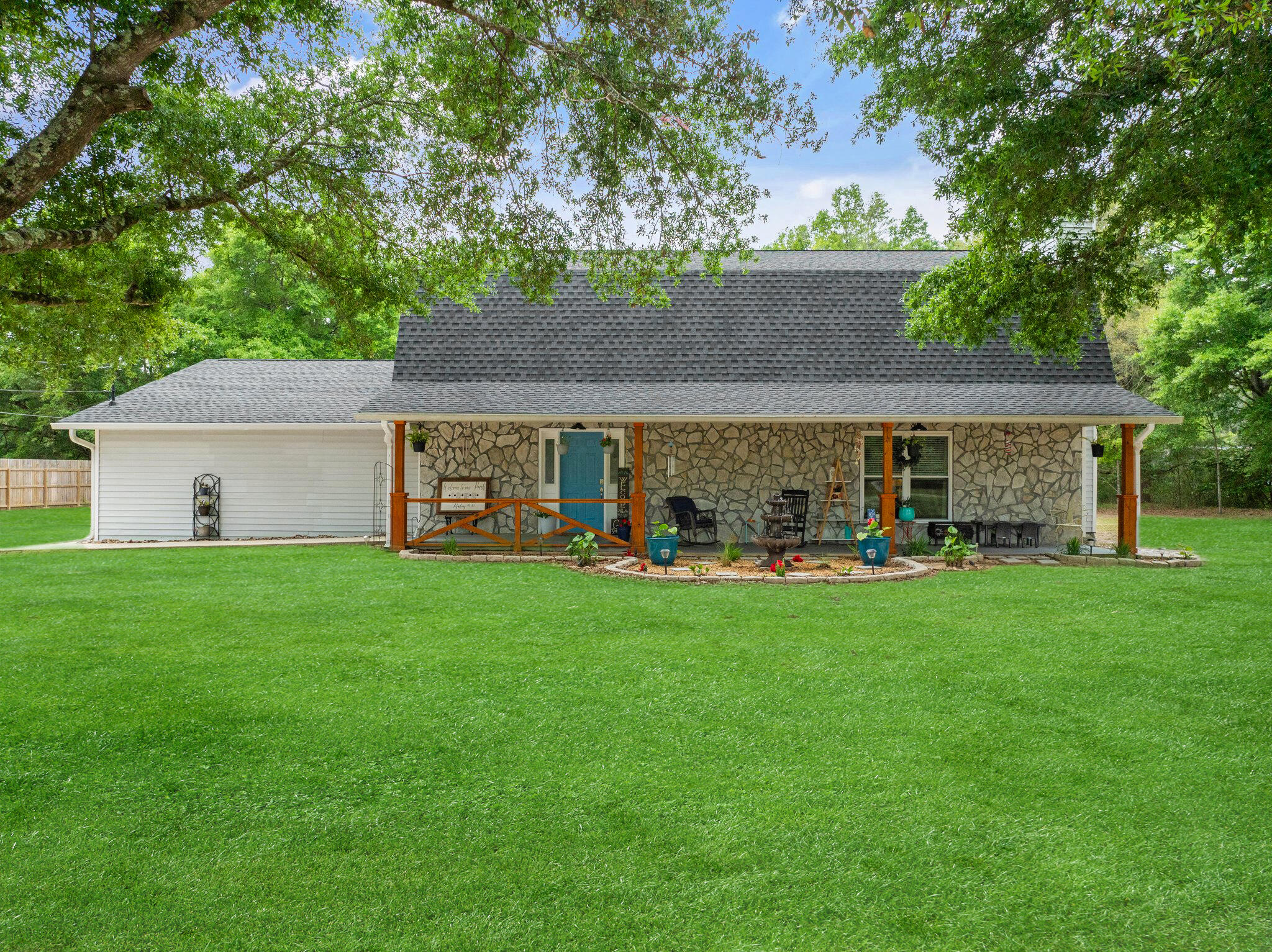 Fantastic Country living for the extended family! Main house w/4 beds 3 bath and 670 sq ft guest cottage with complete with  living room, kitchen, bath, bedroom and washer/dryer!!! Upon arriving you will be greeted with a covered front porch that is so inviting you will want to sit for hours rocking and enjoying the amazing view from the 2-acre lot.  When you enter the foyer, your eyes will be drawn to the large family room with fireplace and the amazing kitchen which has been completely remodeled to include custom cabinets, brand-new stainless-steel appliances and huge island that is perfect for all family gatherings. Truly a bakers dream kitchen! Also on the first floor is a huge primary suite w/remodeled restroom, oversized utility room, storage galore, newly remodeled guest bath