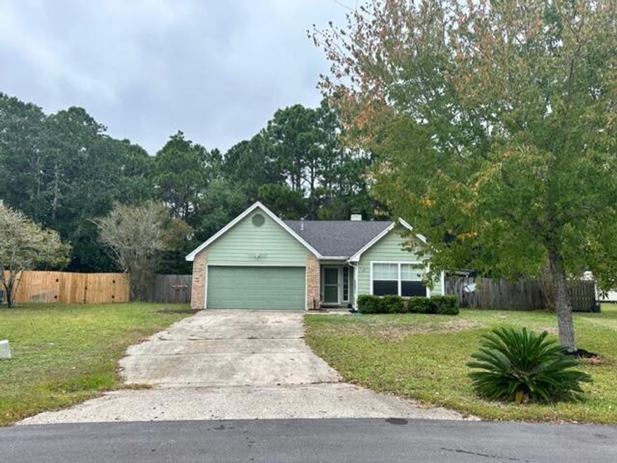 This freshly updated cottage is located in a  neighborhood that is just off of HWY 98 in East Navarre, making it near the beach, shopping and schools. Step into the tiled foyer and notice the brand new LVP flooring that runs through out the house. The home has just been repainted in a cool costal color that will blend with any decor. The Living Room offers  tall ceilings, with fireplace, ceiling fan and sliding doors to the screen in porch. Kitchen has beautiful custom painted cabinets, with almost new stainless Fridge  w/ ice maker, Glass Top Stove, Dishwasher and Microwave. As well as the spacious  Kitchen/Dining Area. Hall bath has been updated with large tile walk in shower, toilet, marble counter and lighting. All bedrooms have new flooring and paint. Each offer fans and plenty of