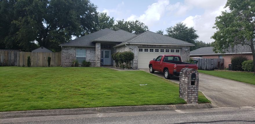 Nice 3 BR 2 bath modern home with vaulted ceiling in living area. Split bedroom plan lots of privacy. All brick, screened porch, brick patio with fire-pit. Wood fenced yard with a big live oak in the back yard, shady and cool. Plantation blinds, trey ceiling in the master bedroom, his and her closets in the master bath. High ceilings and a beautiful fireplace! Underground utilities and public sewer.