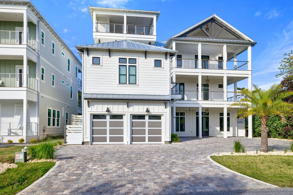 The Beach Escape truly holds up to its name. This exquisite property exceeds all expectations, whether full time, second home, or vacation property. This home has all the amenities of a coastal vacation and within a few minutes to three beach accesses. This four story  Coastal Beach House hosts beautiful porches and walkover to carriage house. The fourth floor lets you gaze at breathtaking gulf views and amazing sunsets. This property offers spacious room for living or vacation rental with seven bedrooms including full bunk room, gourmet kitchen, gas range, wet bar, wine cooler, and pot filler. Perfect for entertaining. The dining and living area with its Euro doors opens up to a large covered lanai. Enter into a resort style pool with hot tub , waterfall, and fire pods. Outdoor kitchen comes with bar-b-q, soda cooler, icemaker, and sink. Alo, lanai has fireplace and there is a putting green for all you golfers. Enjoy watching all your favorite sports on large flat screen tv above the fireplace. Carriage House has open floor plan with kitchen and full bath. House comes furnished. When on the first floor and you forgot your flip flops on the third floor, just jump on the elevator. This magnificent house is priced to sell