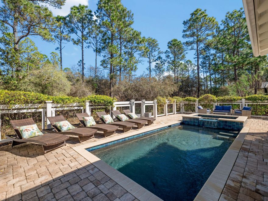 Boasting incredible indoor and outdoor living spaces, this Romair-built home goes beyond four bedrooms and four-and-a-half baths to include a bunk space, wet bar, a formal dining area, gourmet kitchen, multiple porches, a covered carport and a private saltwater pool and spa. To the front, a lengthy paved driveway provides ample parking, while to the rear, a deep porch overlooks the extensive yard, which backs onto mature greenery. Fully upgraded and carefully maintained, this spacious residence wows with newly refinished hardwood flooring lit by imaginative designer lighting features. The open floor plan encourages a seamless flow between dining, cooking and relaxing. The kitchen is the heart of the home and boasts Carrara Gold quartz countertops and Wolf and Sub-Zero appliances, including a wine refrigerator. Imagine laughter and social conversation around the newly repainted island while family and friends perch on stools, sipping and nibbling tasty appetizers before dinner. The first-floor master suite is ideal for stair-free living. It benefits from direct access to the pool terrace for enjoying a peaceful morning coffee while listening to the birds. A guest bathroom, laundry and a large mud room cover storage and other mundane tasks. 

On the second floor, there's an additional master suite and two guest bedrooms, all with stunning private bathrooms. A bunk space provides additional sleeping quarters and a den for four young guests. French doors open onto the upper porch, where a swing bench catches the breeze. Backed by a protected forest, the home enjoys exceptional peace and privacy. Enjoy a dip in the pool, unwind in the whirlpool spa, or read a book on the generously sized screened porch. Noteworthy updates include two new HVAC systems (2024), repainted exterior trim, new pool equipment (2024) and new LED lighting. 

Designed for relaxing and entertaining, this impressive beach house comes with access to the superior WaterColor lifestyle. Families will appreciate Camp WaterColor with its pools, slides and lazy river. The entire community is dotted with pocket parks, community pools and sports courts. Miles of well-kept boardwalks lead to a fully stocked boathouse on Western Lake. The private Beach Club includes a zero-entry pool, bar and a restaurant overlooking the emerald gulf waters. Beyond the gates, Scenic Highway 30A is lined with independent cafes, boutiques and restaurants enhancing the Florida lifestyle. Exclusively used as a second (non-rental) residence, this turnkey home conveys furnished and includes a 2022 six-seat Star Sirius golf cart, making transportation a joy as you explore all that WaterColor has to offer.