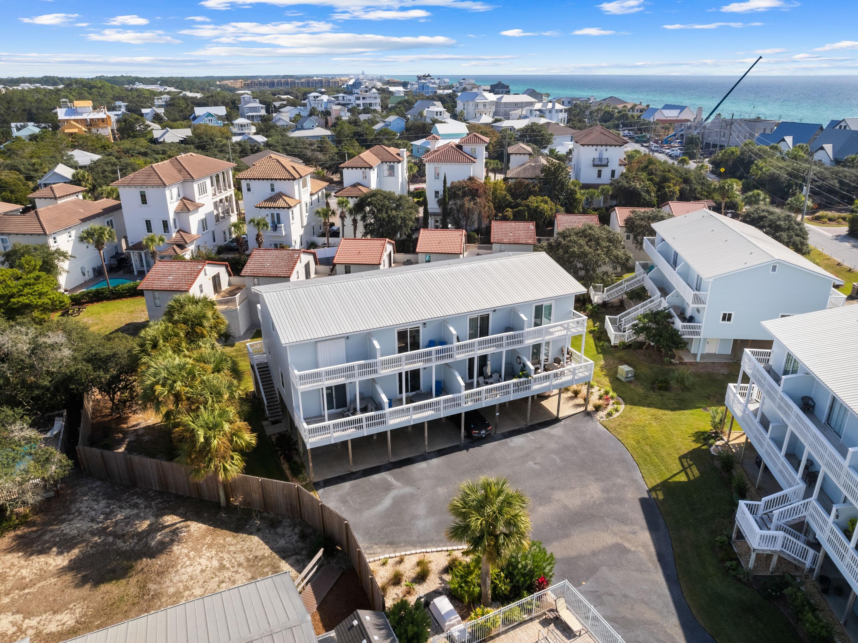 Boasting a great location south of 30A, this adorable beach townhome has been completely updated and presents as new. New flooring, new kitchen appliances and sparkling updated bathrooms make this an outstanding townhouse property at this price point. Access to Blue Mountain Beach is a short stroll away from this spacious retreat. Look forward to morning walks with pelicans and sandpipers, or days spent swimming, sunbathing and shelling in this unspoiled location. Covered parking beneath the home provides shady space for two vehicles plus a golf cart, which is included in the sale. The first floor also has a huge storage space for bicycles, beach chairs, kayaks and other essentials. Head up the steps and in through the door to appreciate the light and spacious living room