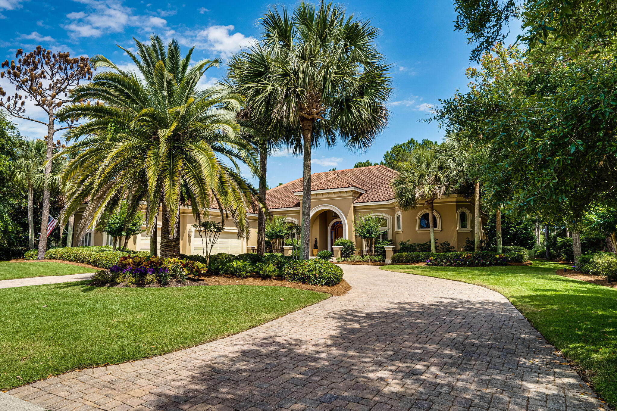 Spread your wings in over 5,000 sq ft of living space in this immaculate home. Pull into the paved circular drive and enter through the double arched front door to immediately enjoy views spanning the screened and heated pool and the 14th hole of Raven Golf Course. This estate home is comprised of formal living, dining and gathering rooms featuring travertine flooring and coffered ceilings with gas fireplace as well as a library/office. The gourmet kitchen includes a 5 burner gas cooktop with range hood, two ovens, warming drawer, large walk in pantry with custom shelving and everything else you would expect to find including adjacent butler's pantry with prep sink, wine cooler and ice maker and a separate climate controlled wine storage room.
