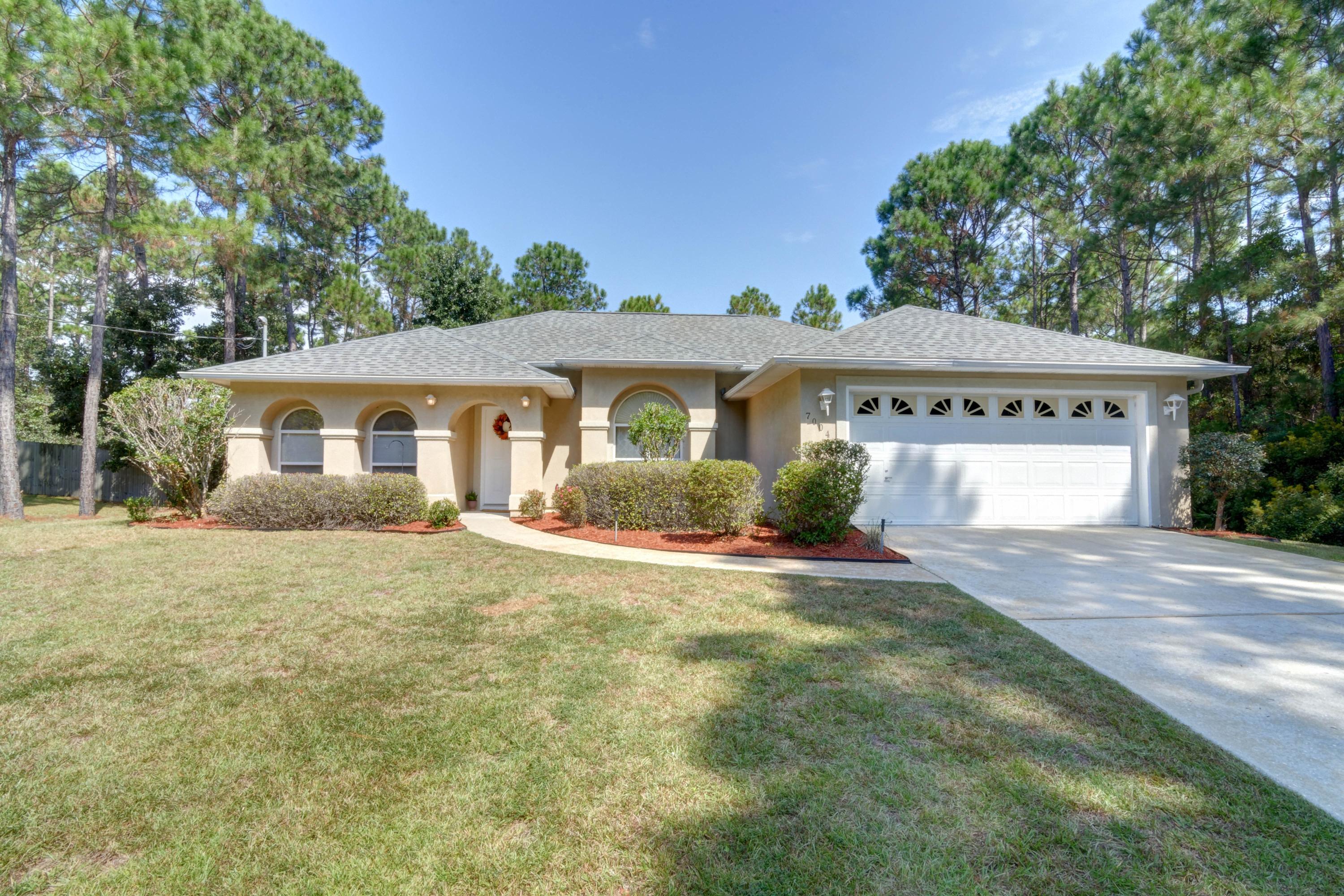 *NEW ROOF* Enjoy one of the quietest streets in Navarre, nestled at the end of a cul-de-sac on a 0.46 acre lot in Holley by the Sea with the land to the front and side wooded, this is the peaceful retreat you've been searching for! Sit on your screened in back patio and relax as you hear the wind blow through the trees and the bird chirp away, enjoy the amenities at Holley by the Sea's multimillion dollar recreation center, or take a short 15 minute drive to see what the Emerald Coast is known for at Navarre's beautiful white powdery beach! Enjoy an open layout and split floor plan with newly installed luxury vinyl plank throughout! Have peace of mind with a new HVAC and ductwork, termite bond, and a brand new architectural shingled roof just installed! Welcome home!