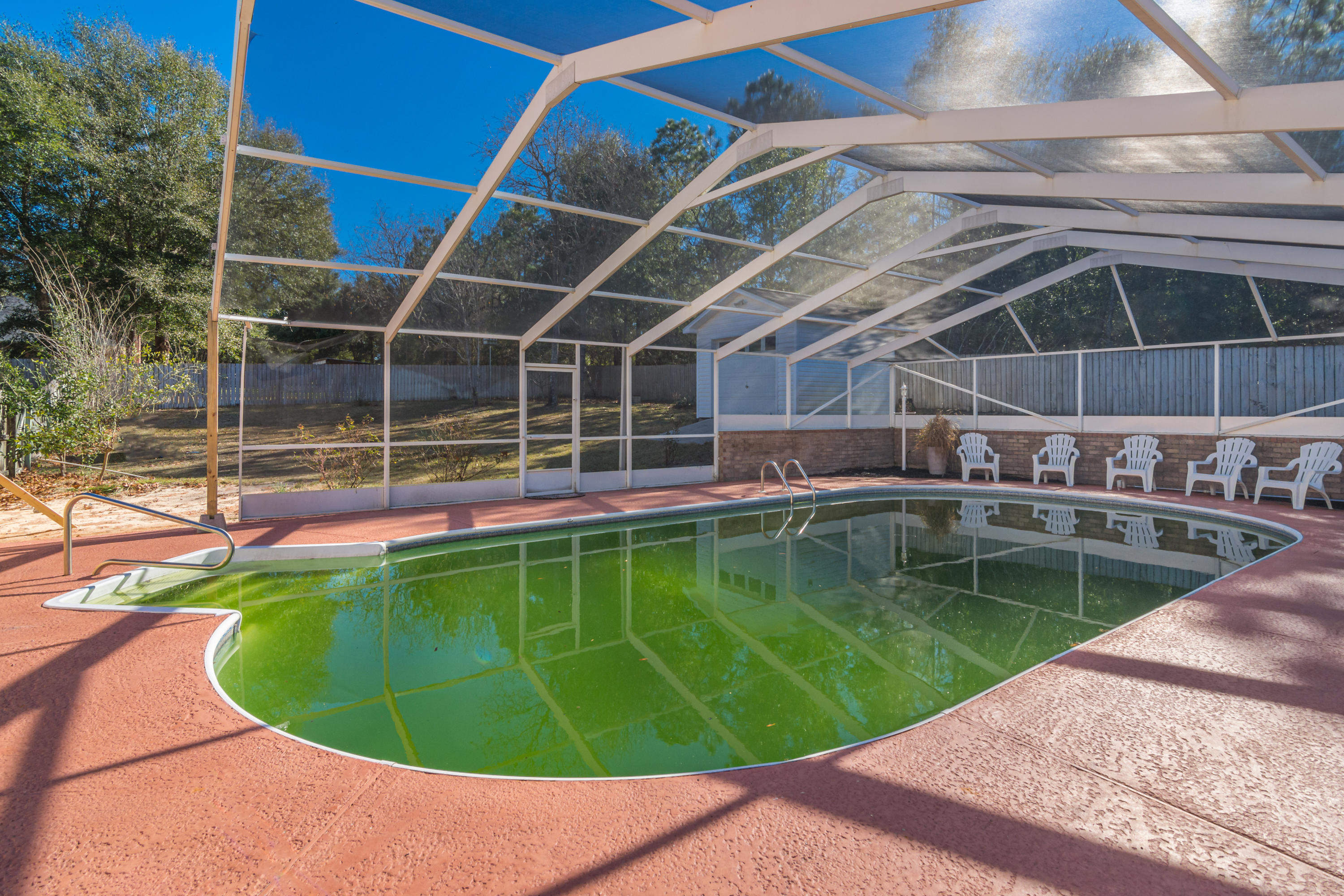 DREAM HOME SITE with POOL! Rare Opportunity! Current improvements in place include IN GROUND POOL with Enclosure, Detached garage/workshop, irrigation system with private well, fence, and fruit trees! Formerly this was the site of a large custom home that was struck by lightening and caught fire. The home was recently removed from the site, taking care not to damage any of the existing improvements! The property is cleared and ready for you to construct YOUR dream home to your exact specifications. You may choose to tie the existing pool into your design. This large 1 acre parcel is located in a highly desirable central Crestview location, offers low county taxes and a view of the lake across the street! This lot has SO MUCH TO OFFER! Easy commute to area bases!