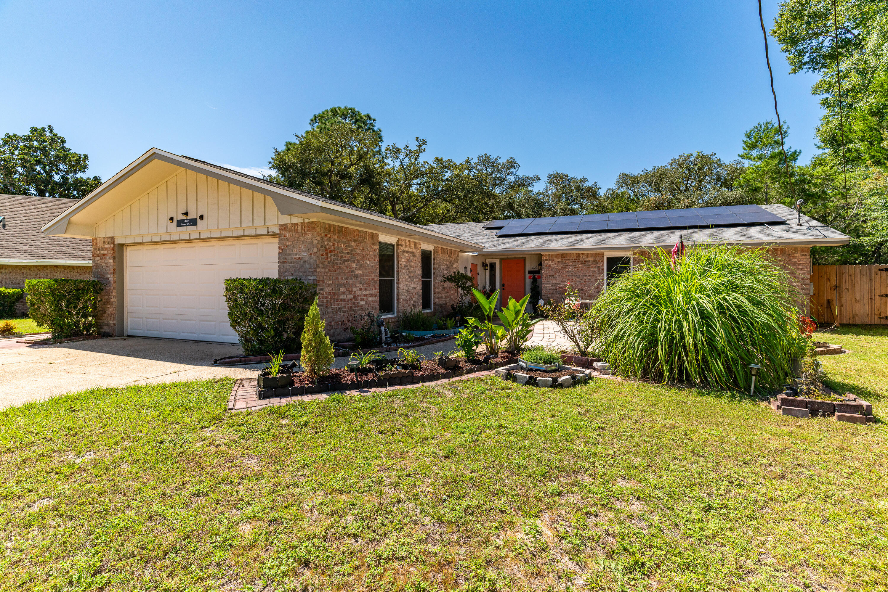 This charming, one-owner home is ready for you! The thoughtfully designed floor plan offers versatility, allowing the front den to be used for multiple purposes. The kitchen and bathrooms were remodeled in 2016, along with numerous other updates. Improvements include windows (2010), HVAC (2014), appliances (2016), roof (2020), interior doors (2022), fence (2022), solar panels (2022; seller will pay off at closing), and a new water heater (2024). Enjoy peace of mind with a longstanding Terminix bond in place. The enclosed space between the house and garage provides ample storage. Situated on a large lot with additional greenspace behind the privacy fence, this home exudes natural charm in a well-established neighborhood with no HOA.  Come out and see it right away!!