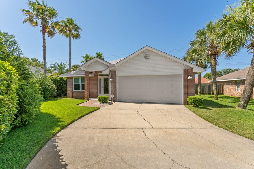 Enjoy privacy and green space views in this completely renovated (new condition and never rented) open concept brick home in Sunsail Subdivision which allows short-term rentals and features a community pool! South of Hwy 98 and just 4 easy blocks from the white sand beaches of the Gulf of Mexico, feel Gulf breezes in the ultimate entertaining space - a 39 ft wide back porch with 14 ft cathedral ceiling includes a fridge and wet bar. Amazing kitchen inside with plenty of storage features a granite center island with two rows of cabinets and bar seating for 6, floor to ceiling pantry with pull outs, upgraded stainless steel appliances with optional convection baking, a warming drawer, and an ultra-quiet dishwasher all complemented by beautiful granite. The primary bath has a spa-like