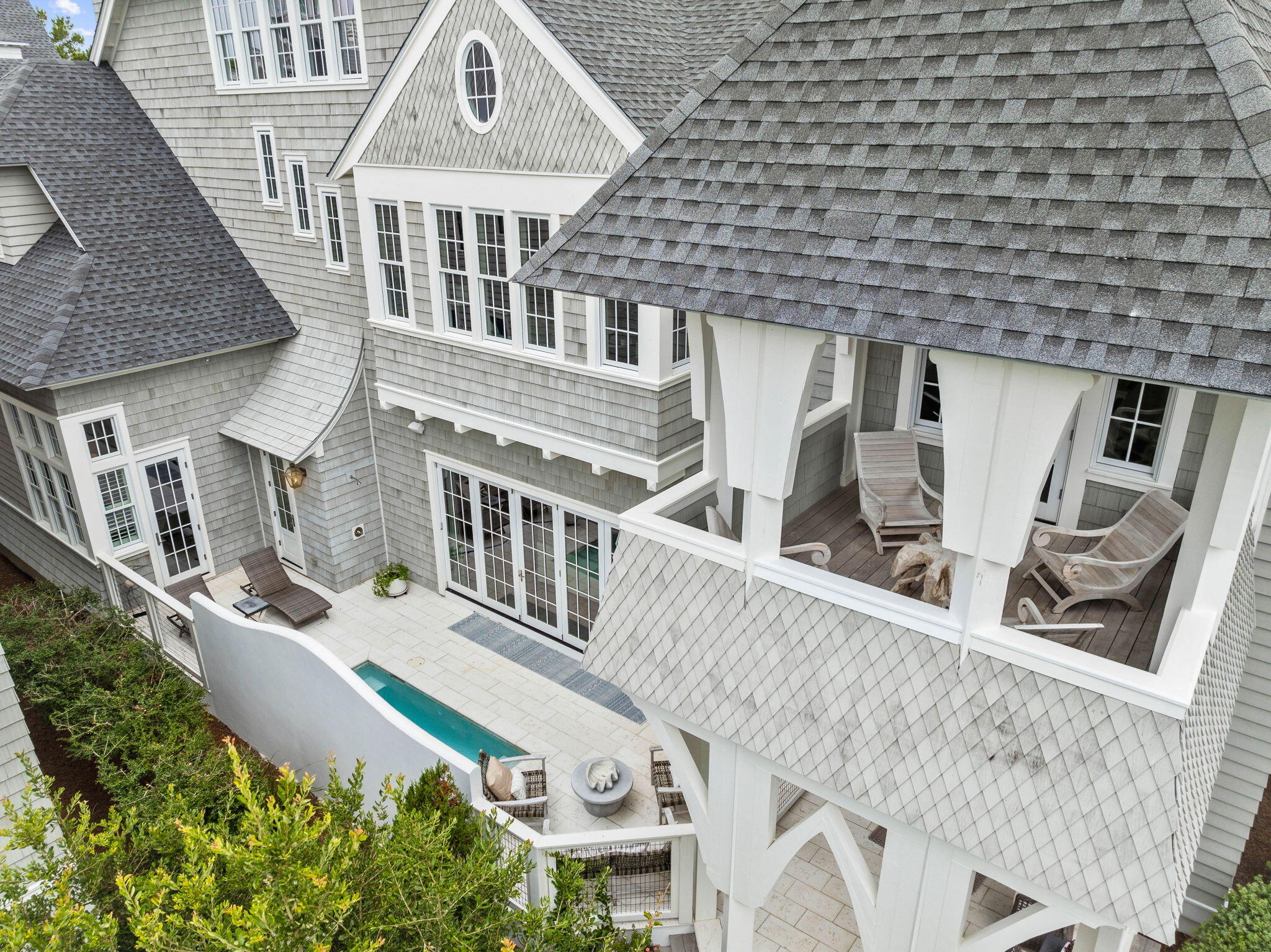 This stunning four-story residence, located within the prestigious Grace Point community, just south of 30A, has never been rented and is elegantly appointed with custom designer furnishings. Ownership in Grace Point includes the opportunity for a WaterSound Club membership, granting access to world-class golf, tennis, a state-of-the-art wellness center, and newly released Camp Creek amenities.Upon entering this sprawling home you will find reclaimed beams and salvaged hardwood floors, Venetian plaster, Carrara marble surfaces, and custom woodwork throughout. The open-concept living/ dining areas seamlessly flow into a gourmet chef's kitchen, complete with custom cabinetry, a professional Wolf range, Sub-Zero refrigeration, quartz countertops, and a floor-to-ceiling pantry. For added convenience, a custom second pantry features a Sub-Zero wine cooler and dual drawer refrigerator. Indoor and outdoor living merge with bi-fold doors that open to a courtyard, featuring a private heated pool and a fully-equipped outdoor kitchen. 
The second floor offers a generous living space with a wet bar, bunk room and three expansive primary suites all serviced by a full-service elevator.  Additional guest rooms, dual offices and not one but two laundry rooms are also found on the second floor along with an oversized two-car garage equipped with an 8,000 lb. capacity lift for a third car.
The third level is where you will find the main suite with a second wet bar and seating area.  This suite features a vaulted ceiling with wood and beam accents, dual walk-in wardrobes, and a sleek ensuite bath adorned with Carrara marble, a double vanity, and a luxurious soaking tub. The fourth-floor viewing deck, the highest in Grace Point, offers panoramic views of the Gulf of Mexico.
