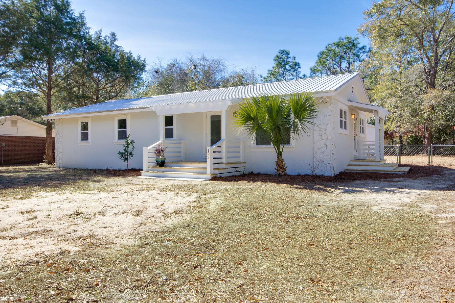 Come check out this beautifully renovated home conveniently located to town. Built in 1972, this spacious home has just undergone a complete makeover. Upon pulling up to the property the first thing you will notice is are the new porches loaded with architectural detail, all new windows and doors, as well as a new metal roof. As you enter the home, you will be welcomed into a spacious living area, and notice burnished hardwood flooring. The kitchen includes brand new shaker-style cabinetry with soft close doors & drawers, stainless appliances, granite countertops, & indirect lighting. Continue down the hall and you will find a full size laundry room including a pantry, the guest bathroom with a double vanity, and a tub/shower combo featuring a porcelain shower surround. All four bedrooms as spacious and appealing with lot of natural light, new drywall, ceiling fans, and custom built-out closets to maximize storage. The master bedroom is spacious with multiple windows and an ensuite bathroom including a tub/shower combo also with a porcelain shower surround. After touring the home, step onto the back porch and be welcomed into your fenced in back yard with a spacious covered patio. A storage building has been included which could double as a workshop, or could be finished out for a private guest bedroom. An additional storage shed is also located at the rear of the property for any yard equipment you might like to store. White Street is a quite road just a few blocks from the Lake Yard, with established homes and long term residents. Enjoy the peace and quiet of this natural setting without being far from the center of town.