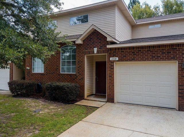 Welcome to this exquisite townhome nestled in a quiet cul-de-sac within a serene Navarre community. As you enter, you'll be enchanted by the open and airy layout, complemented by thoughtful design details throughout.Natural light cascades through large windows, highlighting the beautiful contrast between the dark wood floors and calming paint colors, creating a contemporary and welcoming atmosphere. The impressive 9-foot ceilings further enhance the sense of spaciousness.The kitchen is truly a chef's paradise, equipped with stainless steel appliances, generous counter space, and a convenient breakfast bar that overlooks the living area. A reclaimed wood accent wall adds a touch of warmth and character, while a large window frames a lovely view of the private back patio.