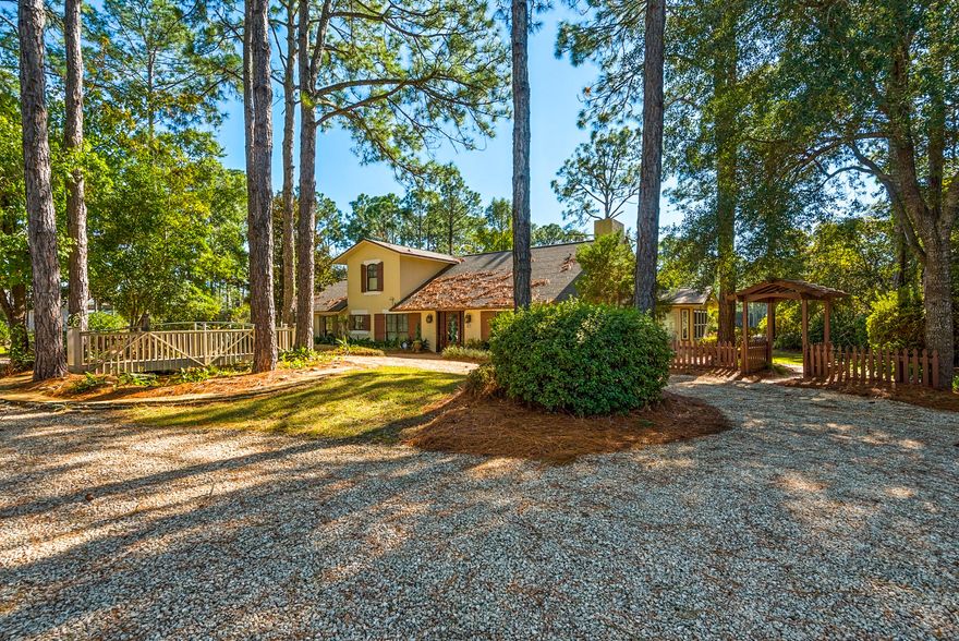 Beautiful residence located on an acre lot with gorgeous views of Fox Lake. Live large in this 4 bedroom home with two master suites! Newly painted, this home has an ideal floor plan offering everything you need on the main/ground floor. Vaulted entry and sunken living area with soaring wood ceilings; wood & travertine flooring. Beautiful kitchen with cherry cabinetry & stainless appliances situated on the south side of the property overlooking gorgeous Fox Lake. Dining area and breakfast bar open out to the back patio where an outdoor kitchen awaits year-round grilling. Paver walkways surround the residence along which lush citrus and banana trees enhance the walk around the property to the backyard.