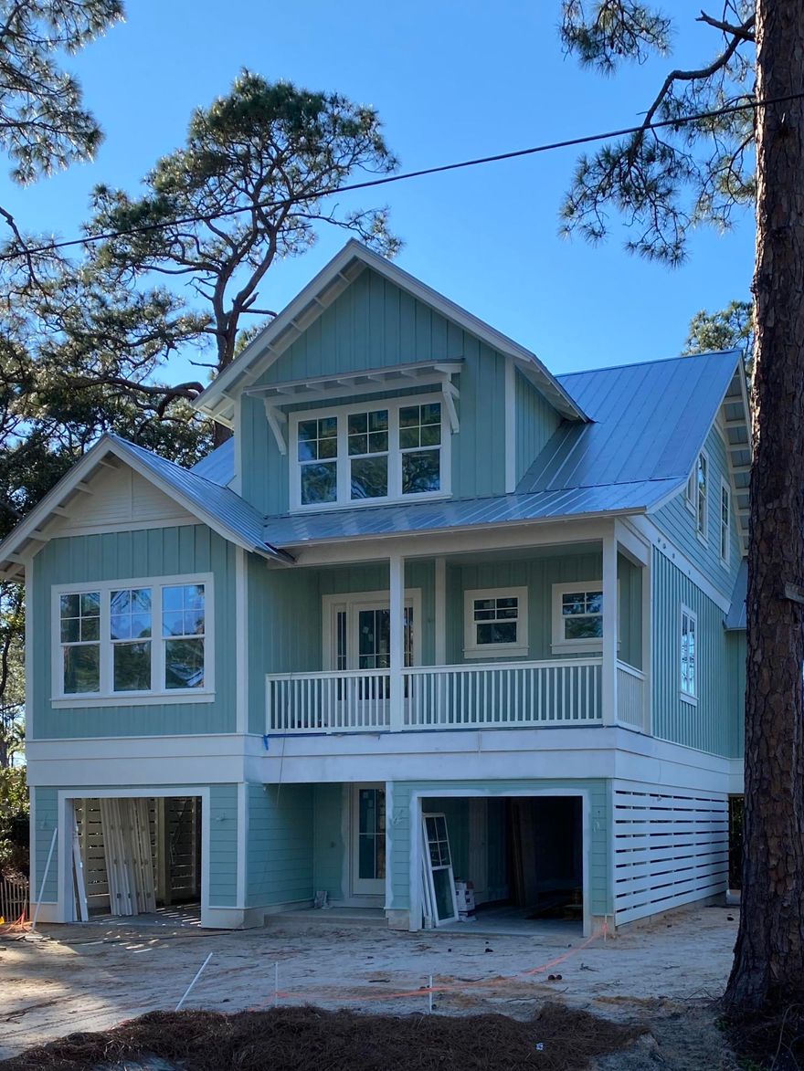 Nestled just off of HWY 30A, walking distance to the beach. Bike ride along 30A to local restaurants, shopping, and beaches. This 4 bedroom, 3 1/2 baths is a great investment opportunity for rental property or beach living at it's finest. 3 story home with an elevator. 2 Garages with plenty of storage. High end Kitchen with quartz counters, stainless steel appliances including Bosch  and Thermador. Gas stove and tankless water heater. Hardwood floors through out the home. Large Master bedroom and bath with dual vanities, marble floors, with his and hers walk-in closets. Beautiful mosaic tile in the bathrooms. Kitchen and dining with a covered deck off the second floor. 3rd floor offers 2 additional bedrooms, a bunk room, media room with an additional covered balcony.
