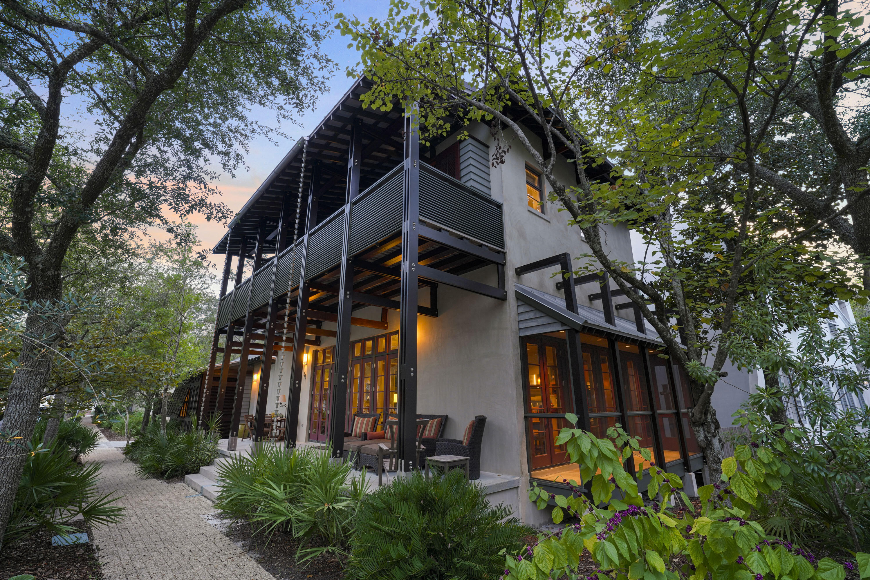 This one-of-a-kind home in Rosemary Beach was designed by Jonathan Lawrence and Bret Azzarelli of Elements Architects in Tampa. Sitting beautifully between Tuckers Lane and West Water Street, it offers over 80 feet of frontage on Georgetown Avenue. With an open floor plan, it's perfect for entertaining family and friends.The owner's suite is a private bungalow with Australian Cypress floors, two walk-in closets, and a bathroom featuring dual vanities and a granite-topped shower. The bungalow can also be locked off for exclusive use. The main house's first floor boasts Black Terrazzo and Australian Cypress flooring, along with mahogany doors. The living, dining, and kitchen areas flow together, making it great for gatherings. The kitchen features granite countertops, a Wolf 6-burner stove, Bosch dishwasher, wine cooler, and a large island with seating for three. The dining space has a table for 10, and the living area includes a cozy gas-assist wood-burning fireplace and a charming library nook.

Upstairs, you'll find three bedrooms, two full baths, and a half bath, all opening to a spacious porch with views of Georgetown Avenue. A laundry area is also conveniently located on this level.

The third floor houses a media area with a wet bar, bonus room, and a half bath, along with another gas-assist wood-burning fireplace.

Outside, enjoy the enclosed courtyard with seating and an outdoor shower. The garage and parking pad accommodate two cars, with additional street parking available. Built with stucco over concrete block, IPE siding, and cedar trim, this home is both durable and stylish.

The home is sold furnished. Don't miss the chance to see this truly unique home.