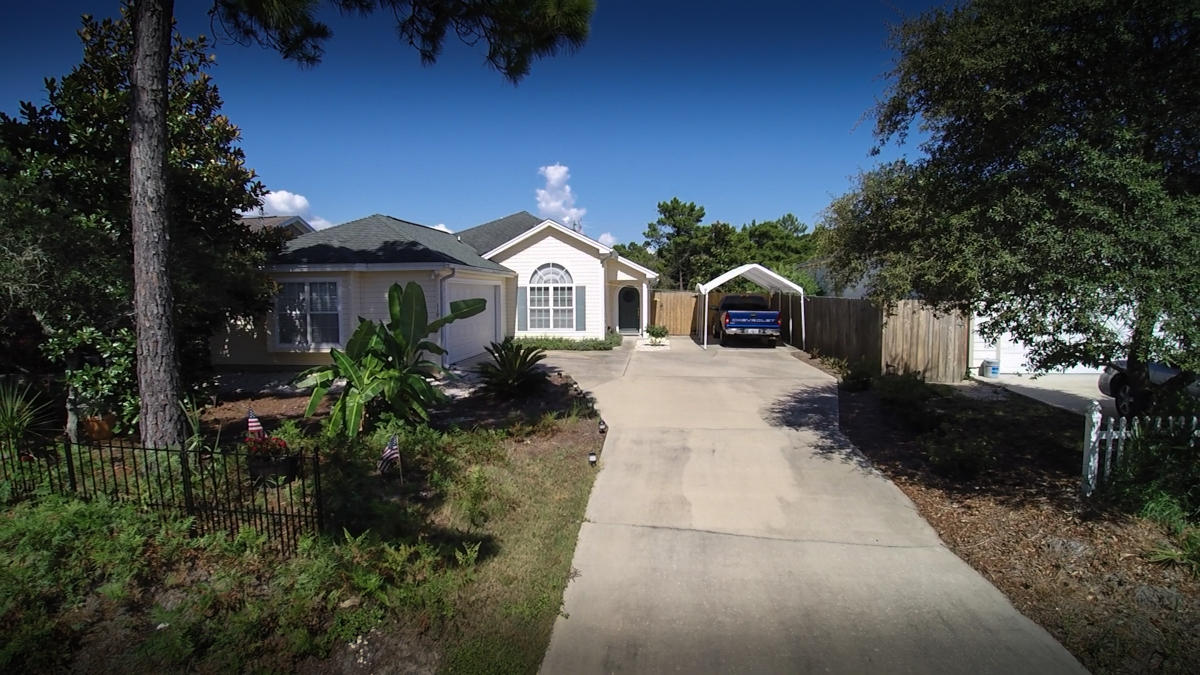 If you want a stunning home with many extras, Plus close to the Beach ? THIS IS IT !Nice screened in porch and 2 GREAT Out Doors cooking/eating areas. Some other extras are the 20x12 extra covered area for parking and a GIANT 24x15 SAIL covering the Open Patio Area. The screened Porch out back is16x9 and leads out to the Outdoor area. Just follow the Stone walkways into the yard and around the corner to the Front. Inside is a Fantastic 3 bed 2 bath home with large open Family room with trey ceilings and the Kitchen with eat at bar and dining room (vaulted ceilings) to boot. Built in 2003 so No Insurance roof issues. Take the short stroll to the Beach access #76 and RELAX. HVAC inside and outside unit recently replaced ASK YOUR REALTOR FOR THE VIDEO LINK***NEW ROOF GOING ON TODAY 1/9/2017**