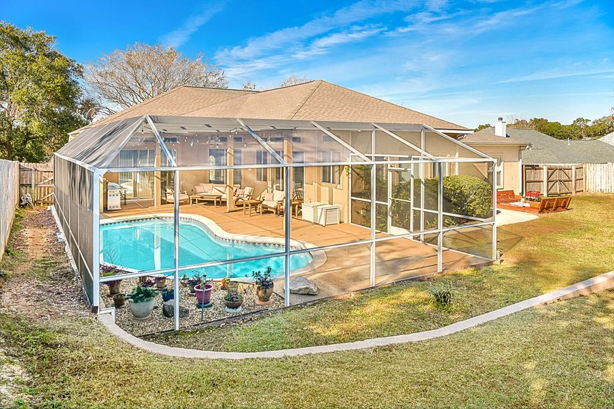 Conveniently located in the Reserve at Carpenter's Creek, this home offers many wonderful updates as well as a screen enclosed heated gunite pool (49X28 screen enclosure) and an In-Law suite, a formal dining and sitting room. Perfect for entertaining, you'll enjoy the cascading sliding glass doors allowing abundant natural light to flood into the home with 12 foot soaring ceilings. The open spacious floor plan includes a breakfast nook overlooking the pool with a huge living/family room and wood look tile throughout the main living area. The renovated kitchen comes equipped with a breakfast bar, beautiful Quartz countertops with mosaic tile backsplash, electric cooktop, wall oven, fridge with a water dispenser and ice maker, and a pantry with additional cabinet storage just off the kitchen