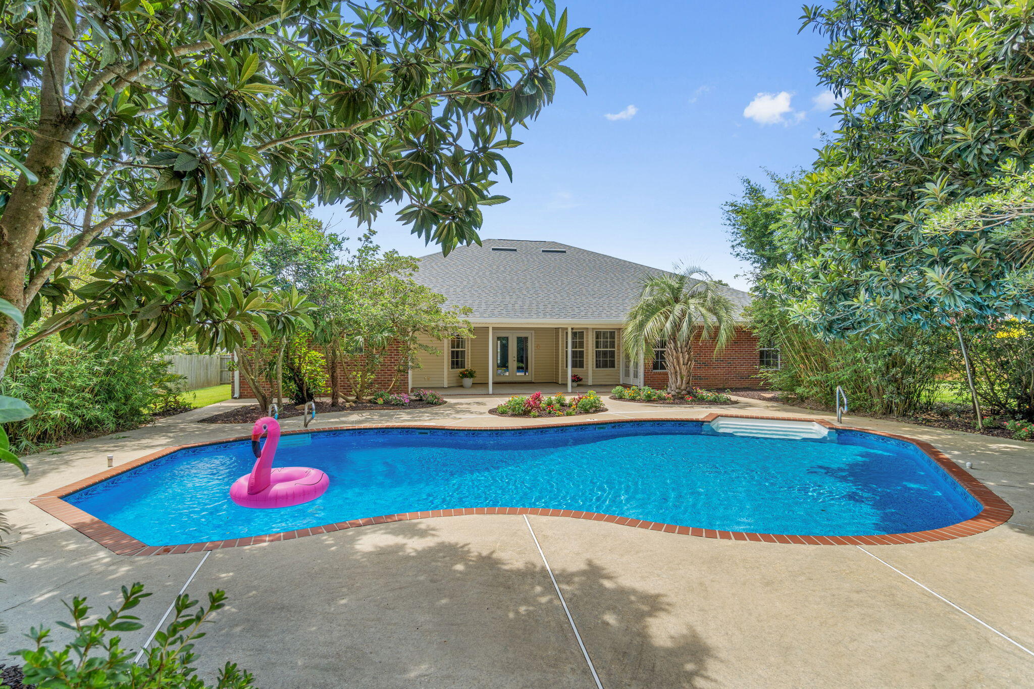 Welcome home to the tropical pool oasis you're never going to want to leave! This stunning and move in ready four bedroom (plus a formal dining room and bonus space/office!), three bathroom home is located in the desirable Gardenbrook subdivision. with an in ground pool on a half acre lot surrounded by lush tropical and mature landscaping that will give you the private retreat you've been dreaming of. The expansive list of seller updates shows the pride of ownership and care taken with this home and you'll have peace of mind with a new roof installed in 2023, an HVAC system replaced in 2020, a new water heater installed June 2025, a new pool liner and pool filter also just installed in 2025, AND a whole home generator! You'll appreciate the curb appeal with the stunning weeping mulberry tree by the brick mailbox and crepe myrtles in the center yard garden. Step through the new front door into the foyer and you'll immediately love the newly installed LVP flooring that extends throughout the entire house with no interruptions and the freshly painted interior! Just to the right of the foyer is the office/flex room and to the left is the formal dining room, both with oversized fans, with a doorway leading into the kitchen. The living room is enhanced with an electrically switched decorative ledge and a gas fireplace with an elevated hearth and two moveable showcase lights. Other extras include surround sound in the walls and ceiling and extra wall outlets. The stunning kitchen features stainless-steel appliances, new quartz countertops, solid wood cabinets, a functional island with electricity, recessed lighting and a walk in pantry.
This is no cookie cutter home, this home was tastefully upgraded and modified from day 1 by the original (and only) owner! The split floor plan of the home allows for privacy, with two great sized bedrooms and a full bathroom off the living room, and an "in-law suite" off a hallway behind the living room with a walk in closet, it's own private bathroom, and access to the back patio (all bathrooms feature quartz counters, undermount sinks, and upgraded hardware and fixtures!) The owner's suite is nestled off the eat in kitchen area (where you can enjoy your coffee and a fantastic view of the pool!) and is a great oversized retreat complete with a trey ceiling and private access to the back patio as well! The owner's en suite features a massive 6'3"x16'4" walk in closet, a corner jetted soaking tub, double vanity with extended makeup counter and new quartz counters (matching the kitchen), a private water closet, linen closet, and a walk-in shower that's getting a brand new glass door installed shortly!
Exit out the brand new back doors and you'll see why the backyard truly has the WOW factor and is made for entertaining, relaxing, and making memories! The in ground Crystal Lake pool has an additional 1 foot of depth for extra fun pool days and is surrounded by a private oasis of landscaping where you'll have total privacy from neighbors! Tucked into the canopy of trees are some hidden spots people of all ages will enjoy, perfect for enjoying popsicles on a hot day or tucked away reading a book, but the backyard was designed with several large grassy areas to enjoy. The fully fenced in backyard also has 30ft tall bamboo along the back of the property providing the ultimate tropical retreat, and when the backyard is in bloom it will take your breath away.
You truly don't want to miss this well maintained gem. Welcome home!
