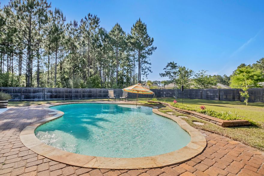 Breathtaking Craftsman-Style, Smart Home, all brick POOL HOME with stacked stone accents, 3-Car Garage and screened covered back porch and 24'x10'patio! Upgrades abound throughout: The kitchen is a chef's dream space featuring granite counter tops. tile back splash, tile flooring, stainless steel appliances to include a Bosch ''quiet'' dishwasher, top of the line refrigerator and more counter space than you will need! An open dining room just off the kitchen which has ample space for all your furniture. The open living room with vaulted ceiling, hardwood floors, stacked-stone wood burning fireplace, and double FRENCH DOORS that open to the screened and covered back porch. You will absolutely love the half acre fenced-in yard, GUNITE POOL, with wet step, paver patio The spacious master bedroom has a trey ceiling, wood flooring and plenty of room for all your furniture. Off the master is the over sized master bathroom with his and her closet space, soaking tub, dual sink vanity with granite counters, tile flooring and separate walk-in shower.

Just down the hall are the 3 additional bedrooms. Each bedroom has a deep closet and carpet throughout. In the hallway, there are 2 additional closets for storage or linens. The hall bath features a tub and shower surround, with a lovely vanity and granite counter top.

The laundry room is HUGE, there are wall cabinets for additional storage, tile floors, a half bath and exit to 3 CAR GARAGE! In the garage there are shelves affixed to the wall, those will convey. The attic comes with pull down stairs and almost the entire 3 car garage attic space is usable for storing items. Outside there is an RV and Boat pad for parking, 20/30/50 Amp  with junction box, and 2 portable sheds that convey. In addition, this home has hurricane protection for the windows -

This is a SMART HOME:  LED Lighting throughout the home, 1 Nest Thermostat, 2 Nest Protect CO2/Smoke Detection System, Vivant Home Alarm that connects to the Nests, Wifi Security Cameras, lights that can be dimmed, thermostats can be changed, doorbell with a camera so you can see who is home  - ALL FROM YOUR PHONE!! 
