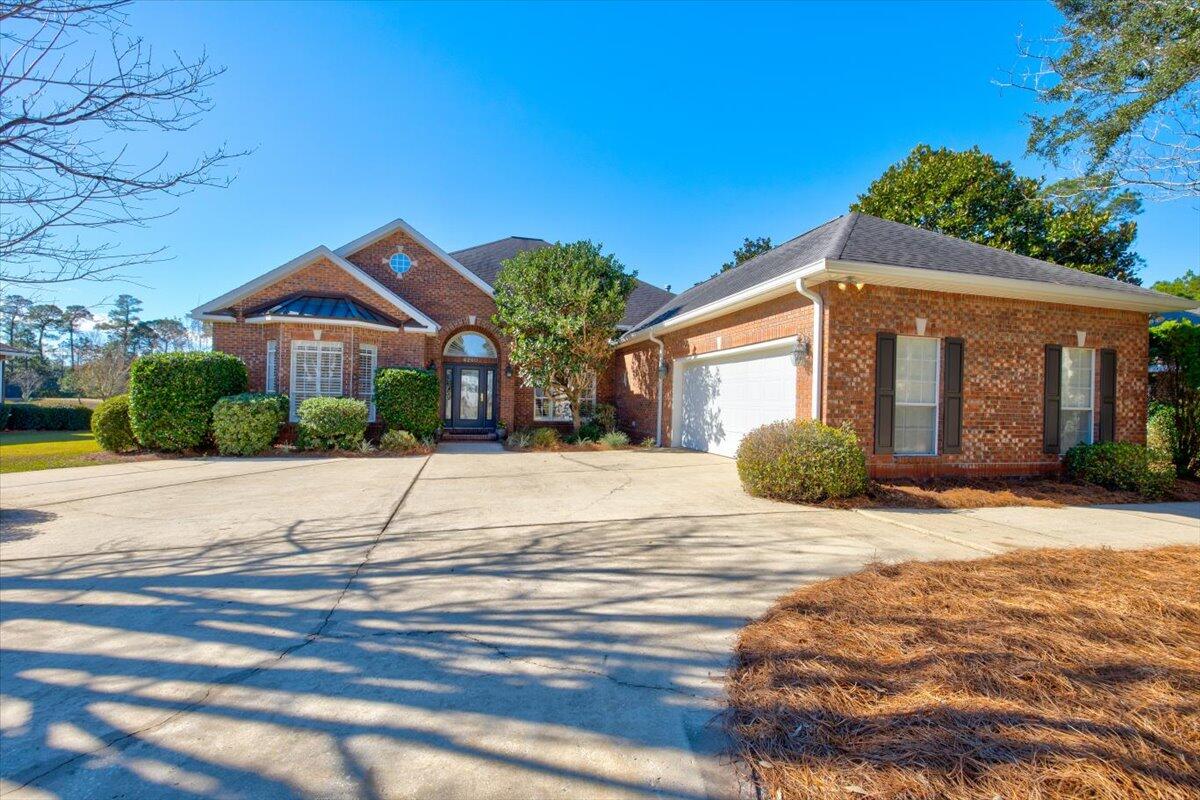 Beautiful lakefront home in the highly sought after gated community of Magnolia Plantation at Bluewater Bay. This 2,800+ sq ft, 4 bedroom, 3 bath home boasts high ceilings, crown molding throughout and custom hardwood flooring. The spacious floor plan offers a myriad of additional features including a separate laundry room, custom maple kitchen cabinets, large kitchen island, plantation shutters, expansive screened porch and oversized 2-car garage with golf cart entrance. The master suite features a sitting area with lake view and an en suite bathroom with double vanity, soaking tub and spacious walk-in closet. Enjoy the breathtaking views of the lake from the entire back of the home. As you step outside onto the screened porch, you'll be drawn in by the beauty and serenity of the lake.