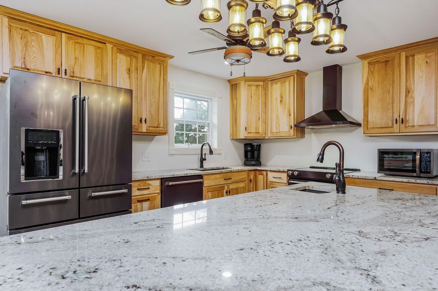 *UNDER CONTRACT. SELLER STILL ACCEPTING SHOWINGS AND BACK UP OFFERS*Privately nestled on 5 acres with a massive (40'x20') metal barn/storage building, this home offers a gorgeous fully renovated kitchen with an open floor plan and a bonus living space. The storage building is ideal for RV or boat parking and has power with 2 roll-down doors. Connected to this space is an additional storage area (20'x20'). The kitchen comes equipped with beautiful granite countertops, large kitchen island with breakfast bar, pantry, high end Kitchenaid appliance suite, prep sink, ample cabinet storage and soft close drawers. Just off the kitchen is a den or additional living space that connects to the powder room and oversized laundry room. You'll also enjoy the designated office space and formal sitting/di