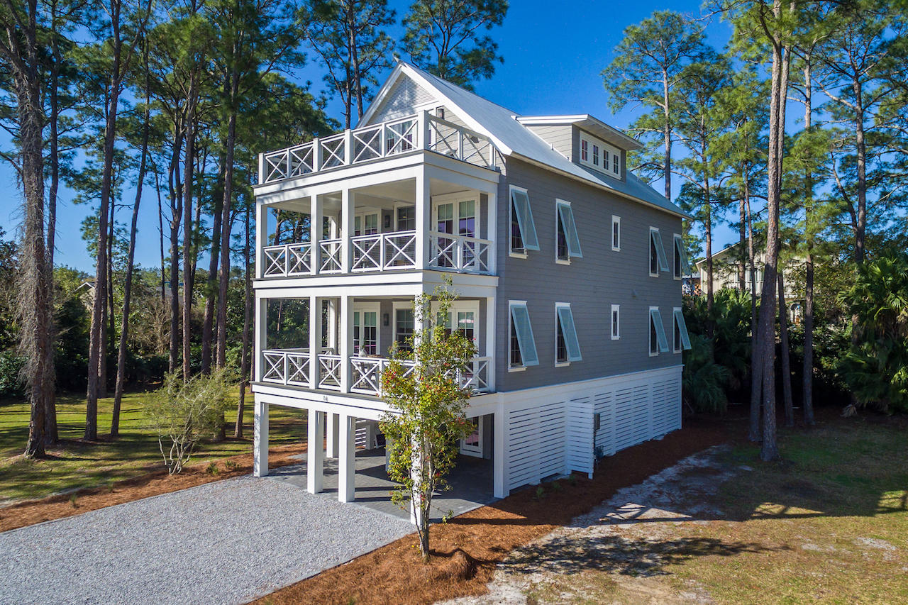 Home is under contract with a 72 hour Kick-out Clause. This GORGEOUS model home is now available for purchase! This 5 bedroom, 5-1/2 bath fully furnished custom built home is a family or investors dream. This exquisite Magnolia Floor Plan custom built by local builder Luke & Blue boasts almost 3600 SqFt of living space and spectacular views of one of the most beautiful coastal dune lakes. Each floor of this home provides impressive views of Western Lake all while overlooking the community swimming pool area. Open concept living is truly represented in this home. Behold the lake views as you enter the 2nd floor into the inviting custom built kitchen. The solid wood cabinetry with dovetail joinery and cushioned close hardware, marble countertops, Wolf 36'' 6 burner all gas range and