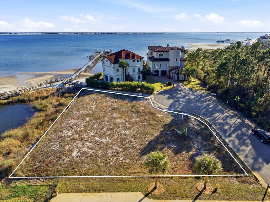 Welcome to the desirable gated community of Palmetto Preserve--home to one of the last remaining waterfront lots in Navarre.MORE PHOTOS IN THE NEXT 48 HOURS! This exceptional property offers pristine water clarity, deeded beach access, and a private boat slip--a rare privilege, as not every home in the community has one. Build your dream home and enjoy immediate access to the water from day one.Located in East Navarre, Palmetto Lake Preserve is conveniently close to top-rated schools, shopping, and Hurlburt Field Air Force Base, while still offering privacy and tranquility. The low HOA of just $115/month truly delivers value, covering a beautiful gated entrance, underground utilities, well-lit paved roads, a community dock, and meticulously maintained beach access. The lot features approximately 165 feet of total water frontage and spans .39 acres, providing ample space for a luxury custom home. A Geo-Con soil study has already been completed, allowing your builder to review and move forward without delay. In addition, the seller is providing a survey at their expense, along with a potential building floor plan that may be used or customizedvaluable tools to help bring your vision to life.

Nestled in a quiet cul-de-sac, the community is thoughtfully designed with a Y-shaped entrance leading to two cul-de-sacs, creating minimal traffic and a peaceful setting. With only two neighboring waterfront homes, you'll enjoy exceptional privacy.

Spend your days dolphin watching, boating, kayaking, fishing, and soaking up the Florida sunjust minutes from Navarre Beach.

All showings must be accompanied by a REALTOR?? due to gated access.

This is truly one of the finest buildable waterfront lots remaining in Navarrea rare opportunity to secure luxury, lifestyle, and long-term value.
