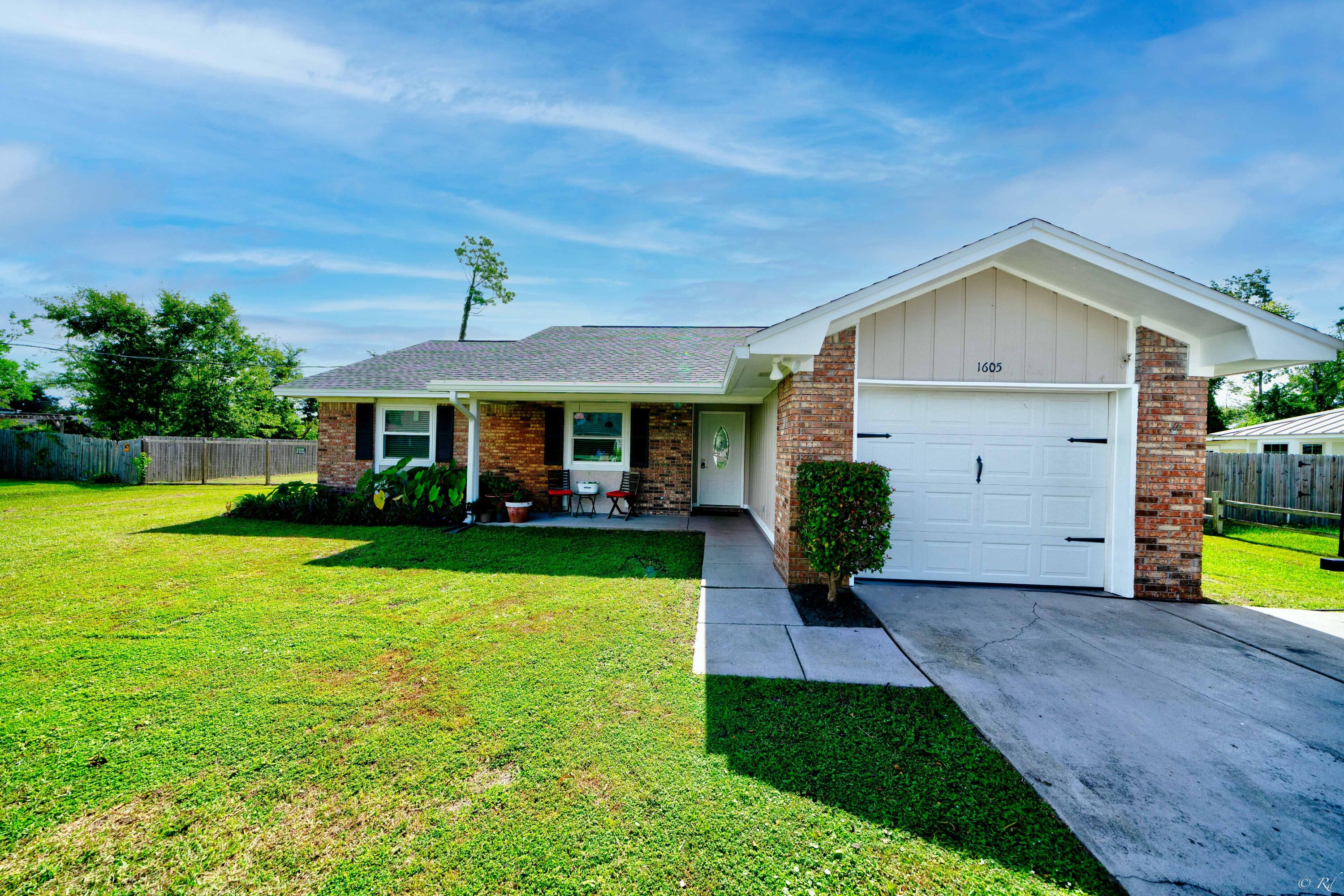 Beautifully updated 3 bedroom, 2 bathroom home sitting on a double lot in the desirable Lynn Haven community! Upgrades include a new roof, new windows, new exterior paint, new fence, new HVAC, oversized tile, LVP, an updated kitchen and more! The spacious living area features vaulted ceilings and plenty of windows to allow natural lighting to illuminate the space. There is also access to the screened-in back porch and backyard from the living room. The eat-in kitchen is equipped with stainless appliances, granite counters, a farm style sink, new cabinets, tile backsplash, breakfast bar and a pantry. The spacious primary bedroom features a walk-in closet and a private en suite bathroom. The private primary bathroom features a shower/tub combo and an updated vanity.