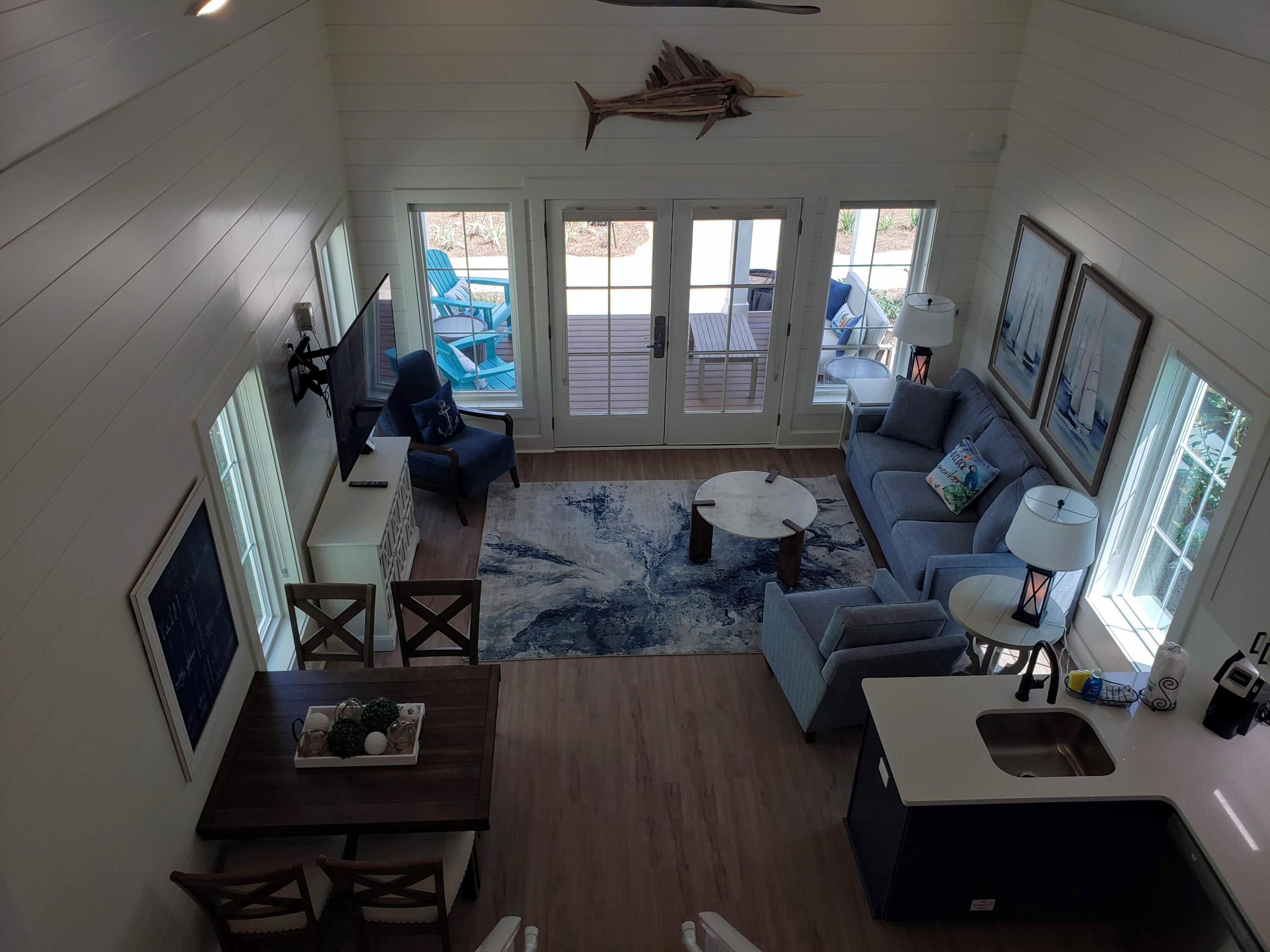 Be among the first to discover this thoughtfully curated and efficiently designed home in a charming ''surf village'' at Margaritaville Beach Cottage Resort in Panama City Beach. The Longboard plan lets you connect and gather on your front porch or step inside to explore 760 sf of heated/cooled space perfectly designed to fit your every need. These charming tiny homes feature a bedroom with a king bed and bath on the first floor and a sleeping loft with built-in full over full bunk beds on the 2nd level.