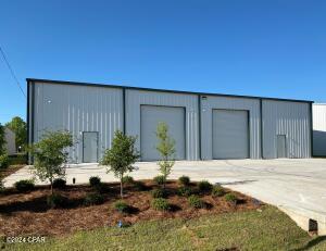 New 5,000 square foot street-level warehouse now under construction in the new ''Beach Business Park''. Includes: 16' clear-height at the eaves, #2 12'W x 14'H rollup doors, #2 ADA restrooms, #2 electrical panels, 6'' concrete slab, driveway and parking. No office space and it is not heated and cooled. The Site Plan, Building Plans and elevations are attached. Zoned C-4 'Research & Design', Unincorporated Bay County (their version of light-industrial). The attached temporary interior pictures are the adjacent building, which is identical other than the restrooms are in the front corners (per the floor plan).