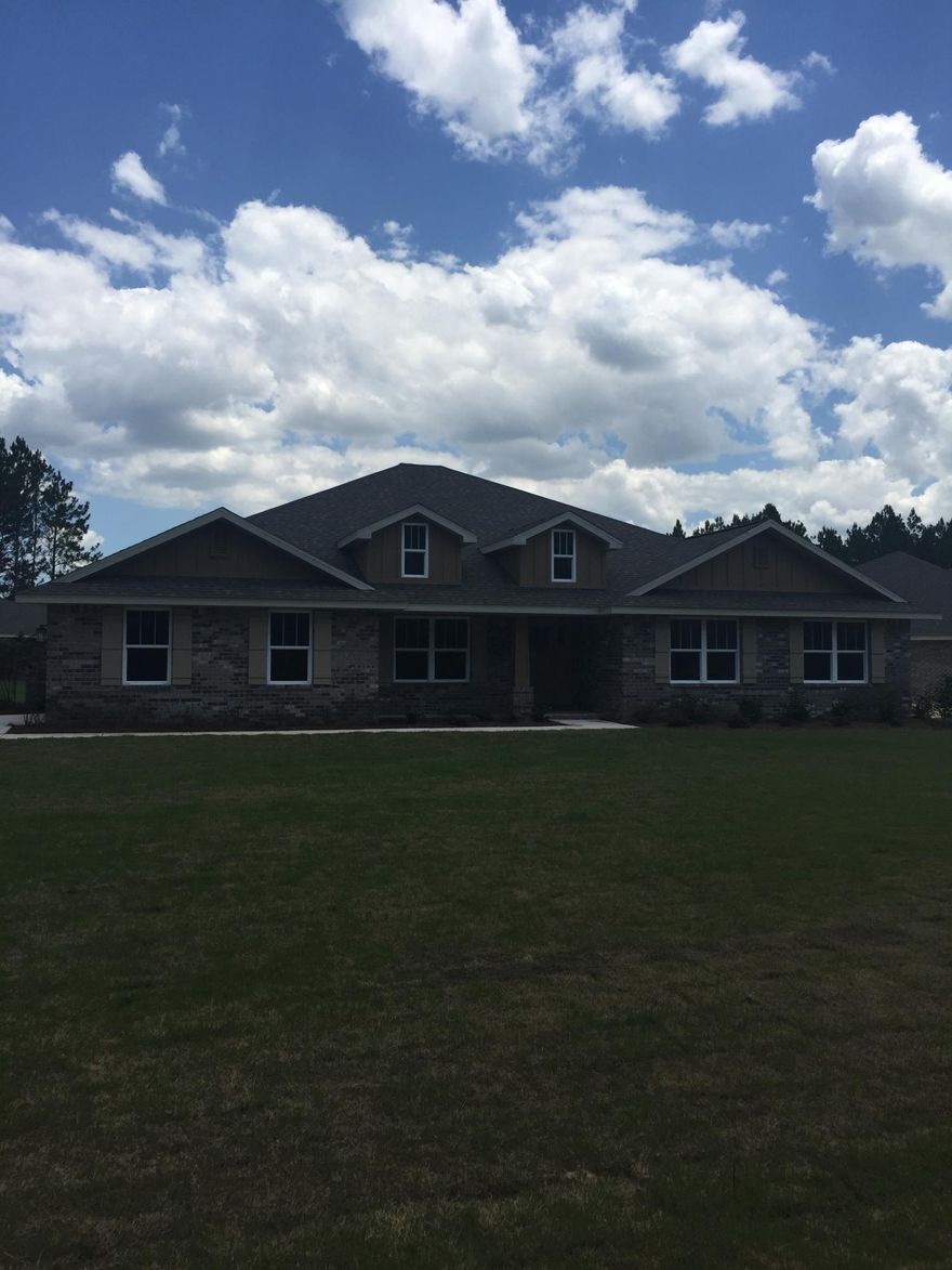 Beautiful home on lake in Symphony at Hammock Bay. This 4 bedroom, 3 bath 3010SF home sits on a huge corner lot and has a side entry two car garage! Traditional brick home with Hardiboard accents. The 39'x10'covered back porch is a perfect place to enjoy the lake views! This open floor plan has large family room with cathedral ceiling and dining area. The kitchen boasts granite counters, beaded cabinets, pendant lighting, separate island, as well as desk area, breakfast nook and large pantry/laundry room. Deluxe master suite with octagon trey ceiling . Master bath has granite tops, separate tile shower and garden tub with tile surround. 1, 2 and 10 year warranties provided. Closings costs paid with approved lender (except prepaids)!