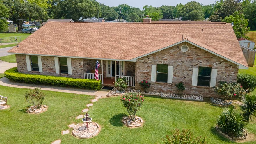 Beautiful brick ranch with an immaculate corner lot and privacy fenced back yard. This home has vaulted ceilings in the family room and features a brick fireplace as the focal point with low maintenance tile flooring. The kitchen has white cabinets with stainless steel appliances, tile flooring with a dining area just off the kitchen. There is an additional formal dining room as well! This 3/2 home has the laundry room located inside the home in the mud room which flows to the 2 car garage. Enjoy a sunny bonus space off the family room that has trendy exposed brick and amazing natural light. The main suite is spacious and the ensuite bath has dual sinks, separate shower, and walk in closet.