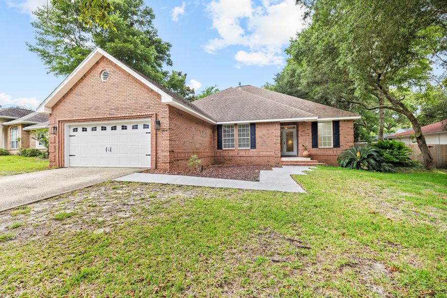 Discover the perfect blend of warm colonial hospitality and brick construction in this 4 bedroom, 3 bathroom home located in the gated community of Parkwood Estates. Spanning 2,433 square feet, step inside to a welcoming foyer and admire 9' ceilings and elegant columns that accentuate the formal dining room and great room. The space is enhanced by a gas log fireplace, a convenient we bar, and durable laminate flooring. The adjacent family room features tall windows built-in seating with storage, creating an ideal spot for reading, relaxing, or watching TV.The master suite is a true retreat with a spacious bath and double vanity, a garden tub, a separate shower, and walk-in closet. An additional downstairs bedroom offers versatility and can be used as an office or guest room.
