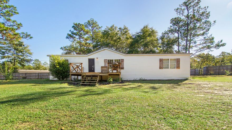 Located in the Mossy Head community this 3BR/2BA manufactured home sits on 4 lots with a complete privacy fenced yard. Home includes a large front porch, newer HVAC system and replaced metal roof. Home has had extensive upgrades but is still in need of remodel finishes in arears.  Home has a large open living room, split floor plan to include a large master suite and master bath with double vanities and separate shower/tub combo and master also includes a large office or nursery attached. The kitchen is open to a dining area and attaches to laundry and exterior making easy for outside play time. The large lot offers also offers a storage area for chickens or tools. Tons of room at a great price. Home is sold as is!