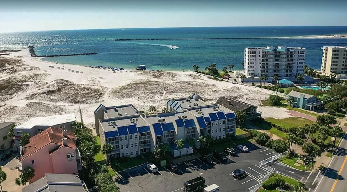 This is a beautiful end unit located in Poolside Villas, an intimate condo on Holiday Isle. The unit has been totally updated with luxury vinyl flooring, fresh paint (no popcorn ceilings), well equipped kitchen, plantation shutters. Couch pulls out to accommodate extra guests. Windows in living room so unit is very light and bright. Short walk over the lovely dunes to the public beach. The drone shots in photo section show the beauty that is found on all sides. BBQ grills. Spacious balcony and another seating area on the walkway into the unit to enjoy the view.