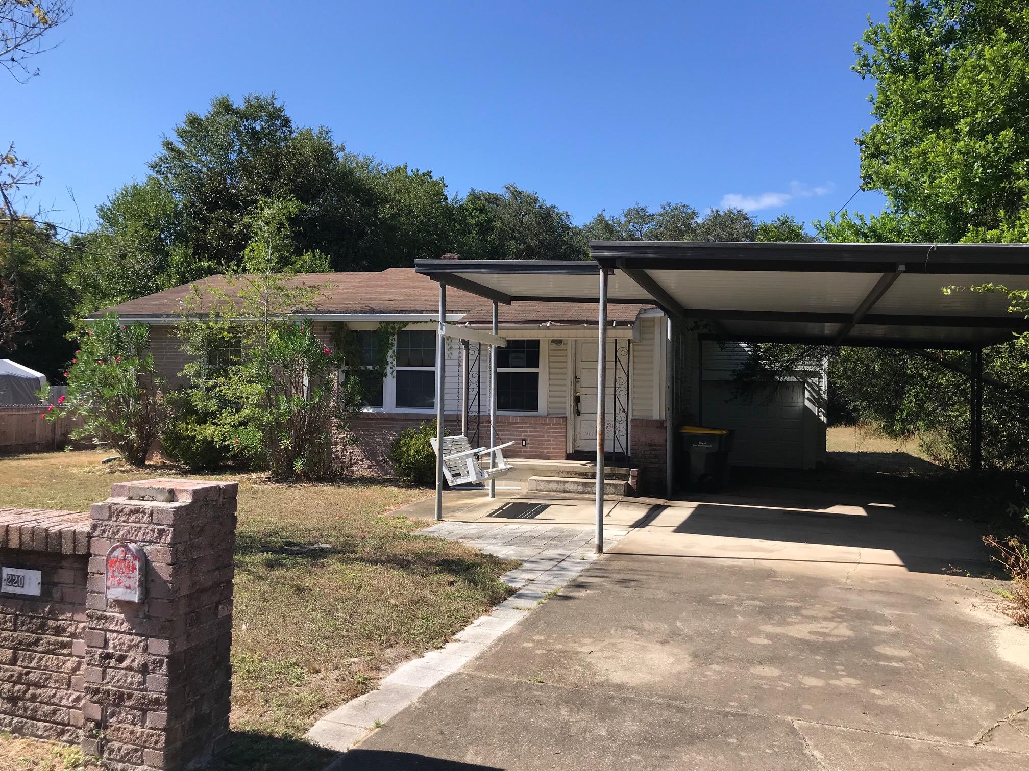 CALLING ALL INVESTORS! cute fixer-upper for sale in Fort Walton. 3 bedroom 1 bath in the main house, plus an area in the rear that was previously used as a separate living area, with kitchenette and bathroom. Hardwood floors. Brick wall. Covered driveway. Large lot. This property does need updates and TLC, but it is priced under value and ready for new owners! Vacant and easy to show.