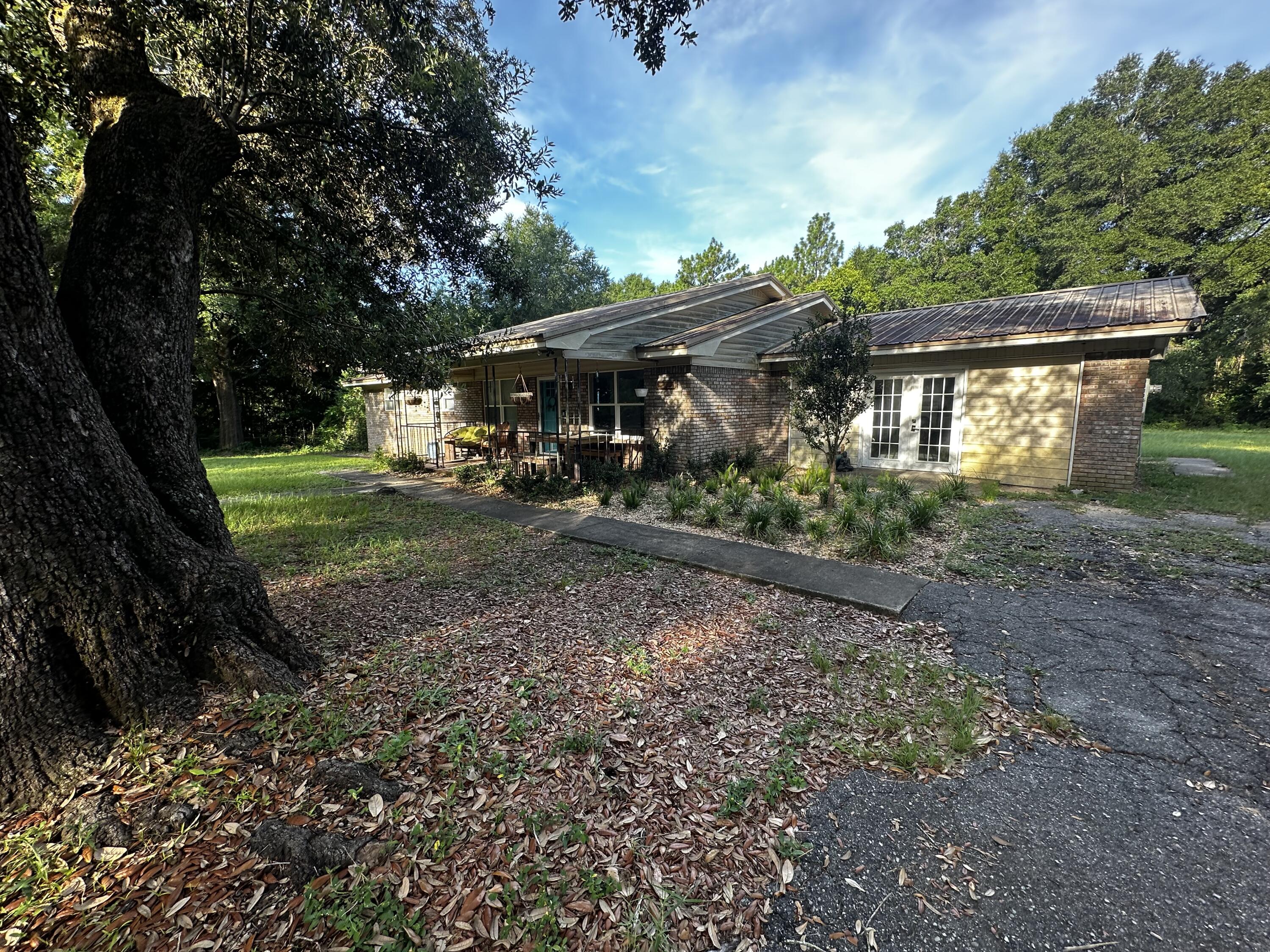 Opportunity awaits in a desirable Crestview location! This 2187 sqft, 3-bed, 2-bath home sits on a sprawling 1-acre lot, offering ample space. Enjoy a recently renovated kitchen, a large open space, plus a living room and a flex area ideal for an office. The fully fenced backyard is a serene escape with garden beds and a shed. Some repairs are needed, but imagine the possibilities in this unique home with a private, landscaped yard.