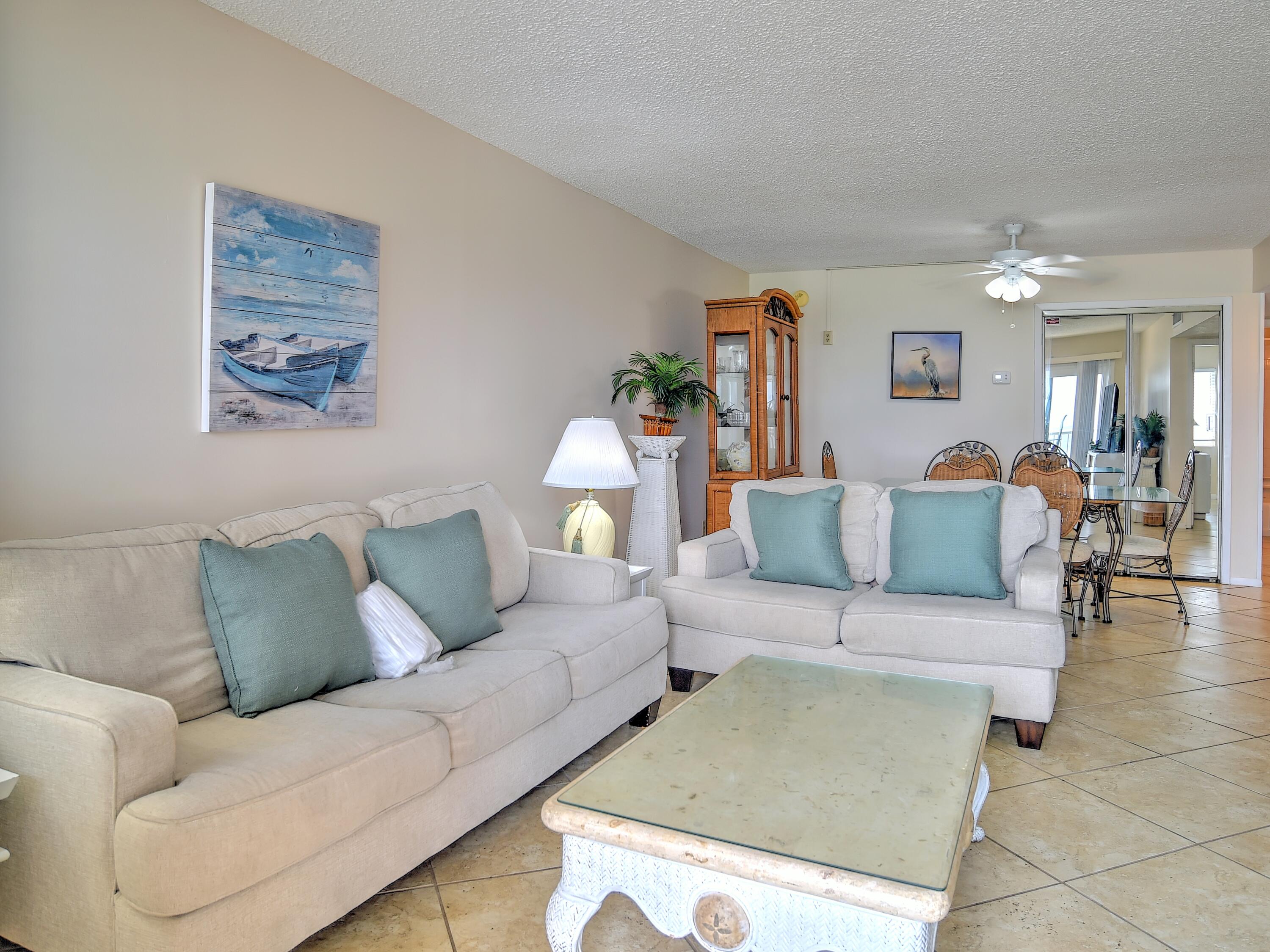 PRICE ADJUSTMENT...Welcome to your waterfront retreat! This delightful 2-bedroom, 2-bath condo, nestled on the 5th floor, presents an exceptional opportunity for those seeking a coastal lifestyle or a lucrative vacation rental venture. With 950 square feet of space, this residence offers a captivating beachfront experience, boasting stunning vistas of the renowned Emerald Coast along the Gulf of Mexico.Step inside to discover a haven of contemporary elegance. The kitchen entices with its sleek quartz countertops, convenient breakfast bar, and pristine white cabinetry complemented by matching appliances. Throughout the condo, 18-inch tiles adorn the floors, adding a touch of modern sophistication and seamless flow to the space.