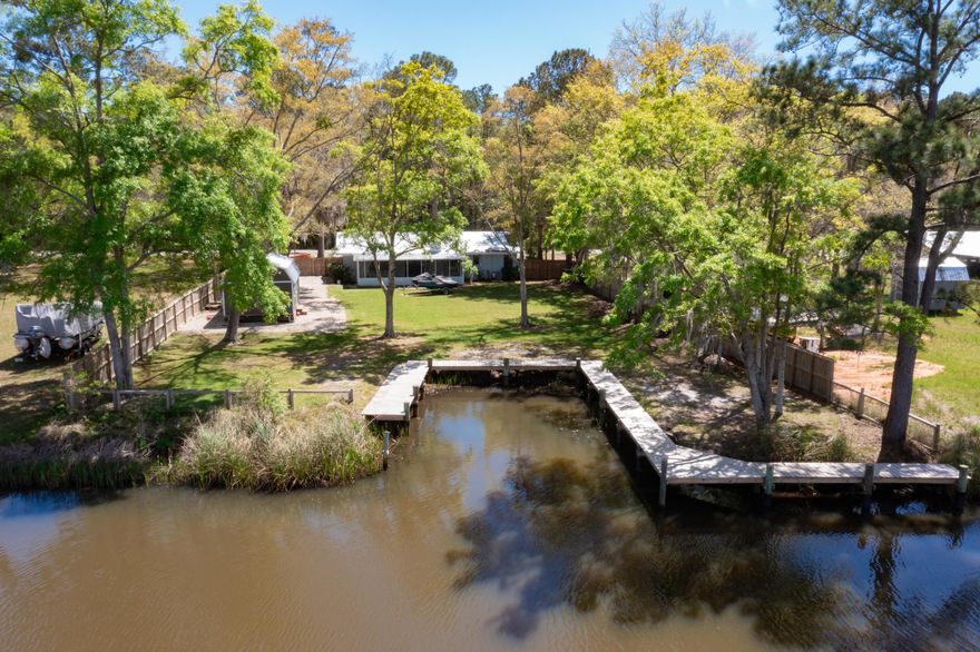 Just across the 331 Bridge, this home on Bay Grove Road is perfectly placed to enjoy all that Bay living on the Choctawhatchee Bay offers along with a 16-minute drive to the Beaches of 30A!  Take a look at this recently renovated Bay house with a protected boat slip and shore lined deck with room to expand.  The Master is waterfront, two guest rooms with shared hall bath, giving way to the large kitchen with island, designated dining area, living room and screened in porch across the back of the house. Newly installed LPV throughout, recessed lighting, kitchen pendants, dining chandelier, interior & exterior paint are just a few of the recent updates. Plenty of room to add on or enjoy it just the way it is. Extra wide lot with 100' on the water, lovely magnolias, and live oak trees.