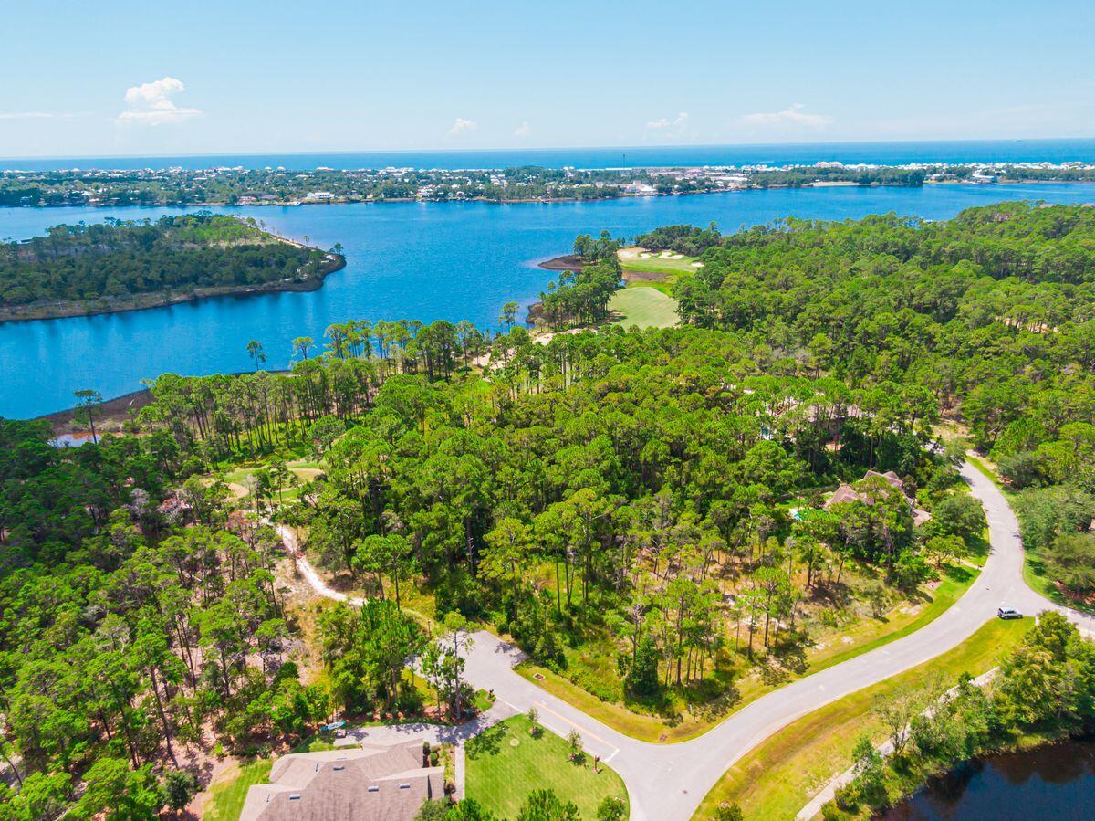 This corner lot in the gated community of Wild Heron sits among native forestry looking out upon an expansive open space with tranquil pond views. This spacious homesite has ample room to accommodate a dream home with the addition of a carriage house and a swimming pool in your own personal backyard oasis. The exquisite amenities in this vast private neighborhood are available for all long-term residents or secondary homeowners who like to enjoy swimming in the community pool, working out at the onsite fitness facility, exploring nature on the walking trails or practicing their golf swing. This property is minutes from shopping and dining in Pier Park and is just steps away from the Gulf of Mexico.