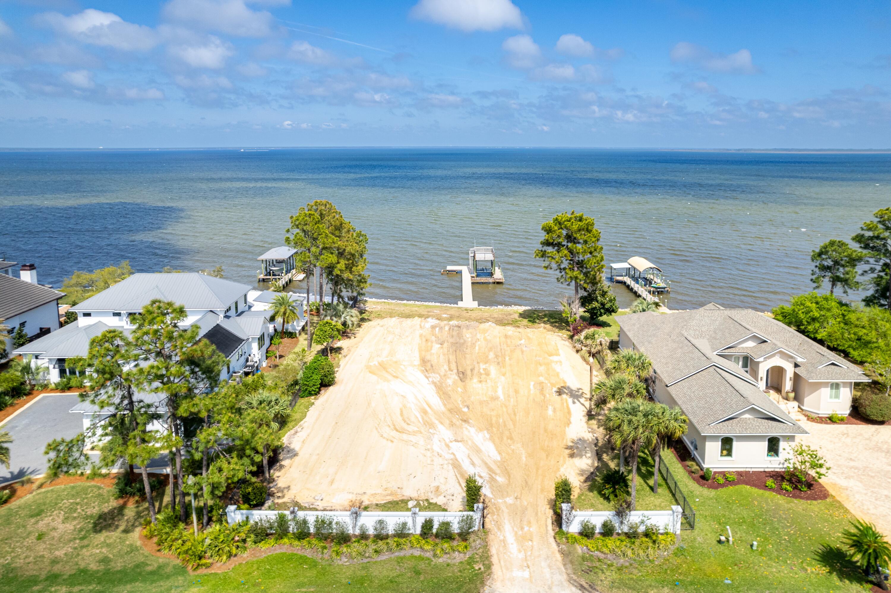 Rare and exceptional opportunity to build a spacious retreat perched on the banks of stunning Choctawhatchee Bay. Take a Sunday Drive down Driftwood Pt. Road where all eyes lead to the water. Escape to a private Oasis with 100' of bay frontage ad endless sunrises. Minutes from the Emerald Coast's finest beaches, shopping, dining and entertainment yet world's away from everyday distractions. Boating is easily accessible with the recently reconstructed covered decking with deck featuring flow through docking. Lot improvements include seawall, front entry fencing, and refurbished dock. Low HOA costs, friendly neighbors, and pink hued sunsets. Discover life on the bay!