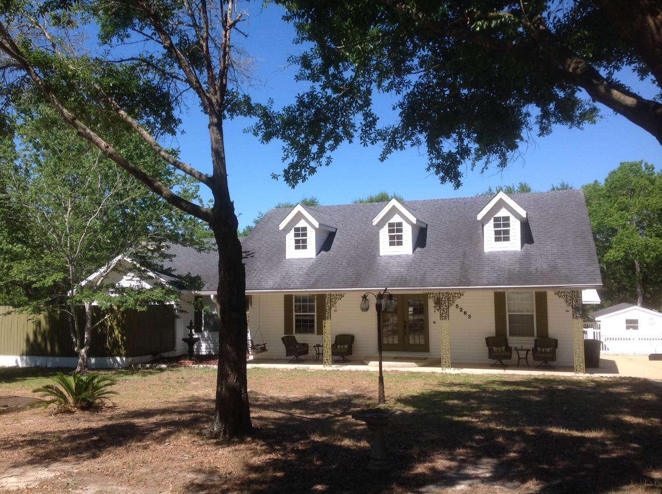MOTHER IN LAW HOUSE! 5 ACRES, CONTEMPORARY MAIN HOME, LARGE DECKS, COVERED AND SCREENED DECK, STOCKED FISH POND WITH DUCKS, INGROUND POOL, SEPARATE GARAGE, CHICKEN COOP WITH CHICKENS, PARKING GALORE and the list goes on! Main Home has PRIDE OF OWNERSHIP from the time You walk in. The Foyer leads to the Open spacious living room with HIGH CEILINGS and a Fireplace. Natural lighting comes from windows up high. Split Floor plan 3 Bedroom 2 Bath. Master Bedroom Large and Master Bath Very Large. There is a Den/could be and is used for a 4th bedroom. Nice Dinning Room, Breakfast Bar and Kitchen Combo Occupies the middle of the home. But that's not all, a separate Office. Now go out back through the 2 Large decks to the 1200 Sq. Ft. Double Wide.