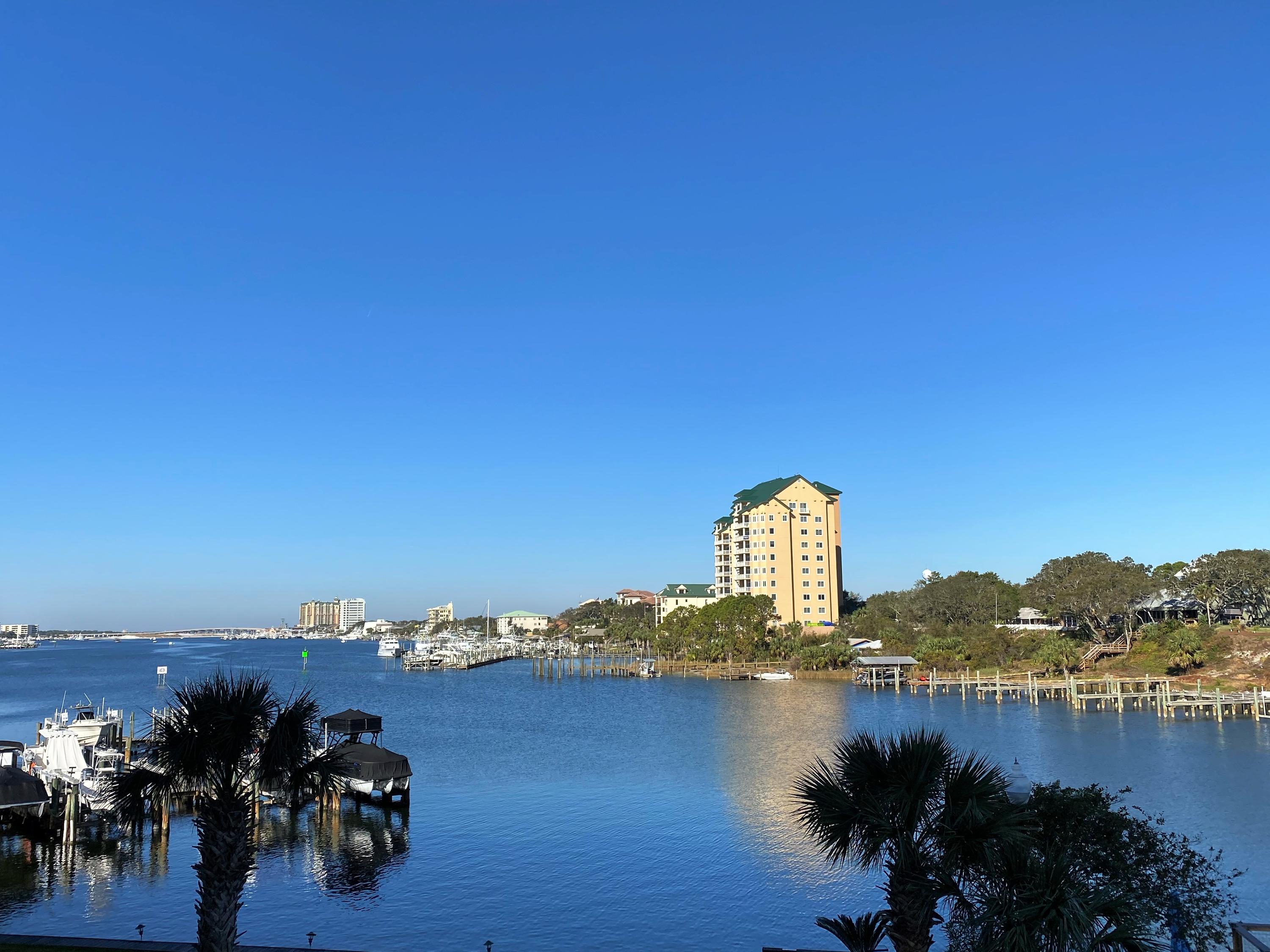 COMPLETELY REMODELED END UNIT w/ INCREDIBLE HARBOR VIEWS! Short stroll to the surf & sun! Complex has DEEDED BEACH ACCESS. Dolphin Point complex allows short term rentals - although this unit has never been on a rental program, so it is in immaculate condition. SOLD FULLY FURNISHED and w/ LARGE STORAGE UNIT. Boat slips available to rent. Sellers spared no expense and installed a washer/dryer in the unit, unlike most at Dolphin Point! Additional insulation was also added in to cut down on electricity bills, as well as updated all of the electrical and plumbing. NEW HVAC! New windows and sliding glass doors are up to FL code. Upscale design features include crown molding with mood lighting above to create a romantic ambience, as well as a cozy electric fireplace in living room. See more --