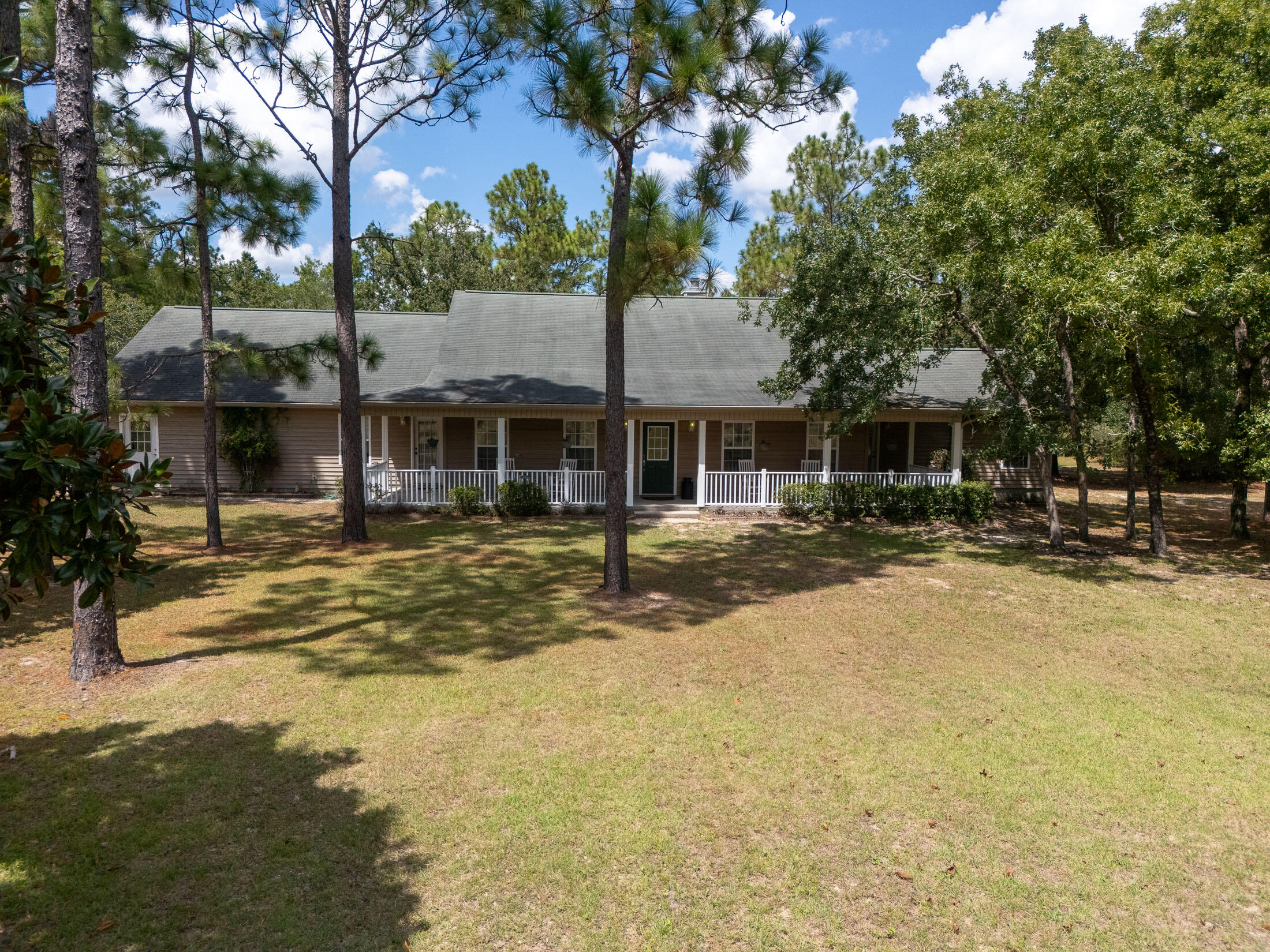 This custom-built, 10 acre generational country estate, features a main house with a pool, a guest house, a workshop/mechanic's garage, a barn, and a detached building with 3 rooms and 2 horse stalls! Hitting the market for the first time since being built, the owners paid close attention to detail when designing this beauty; the Main House was built in 2006, has 4 bedrooms, 4 full baths (3 of the bedrooms have full ensuite baths), approx. 2988 sq ft, thermal pane windows, garage, wrap around porch, screened-in back porch, and is complete with a salt water pool!The Guest House was built in 2004, has 2 bedrooms, 2 1/2 baths, approx. 1275 sq ft, thermal pane windows, a full kitchen, living room, laundry room, 2-car garage, and a screened-in front porch! The Carriage House was built for additional space and also features 2 horse stalls! This building is approx. 864 sq ft, insulated, features thermal pane windows, and has it's own electric panel...just needs some finishing touches to totally complete this building. There are three interior rooms and two 12x12 horse stalls, and there is a rear roof overhang of 8x36.
The Barn is 10x14 and is complete with electric!
There is a detached Mechanic's Garage that is 12x20, has electric, ample outlets, 2 side doors, a garage door, and a ramp! Attached to the Mechanic's Garage is the RV Shed, which is 12x36, has a concrete pad, roof, and 3 side walls!
On the property, there are two 6x8 pump houses/sheds, each over a 350 ft well; one services the Main House, the other services the Guest House.
For an extensive list of owner upgrades/info, just ask your favorite realtor!
This property is the perfect blend of peaceful country living and convenience; 10-15 mins to downtown Crestview and I-10, under an hour to the emerald green Gulf Coast and 35 minutes to VPS airport!
Schedule your private showing today!
All info in the MLS is intended to be accurate, but cannot be guaranteed. Buyer and buyer's agent to perform due diligence.